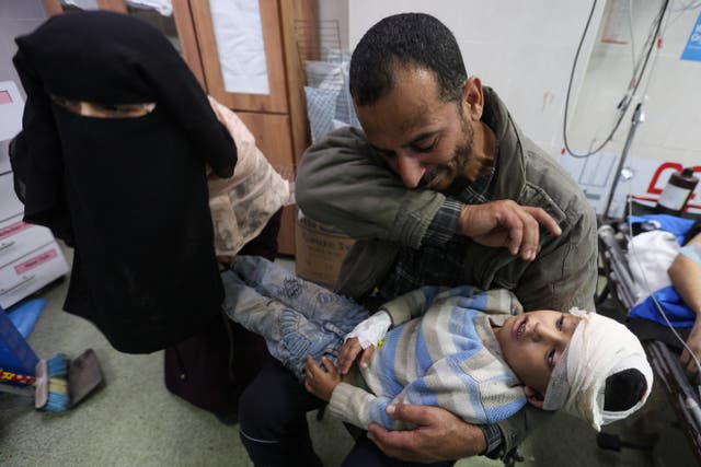 <p>A Palestinian boy wounded in an Israeli strike is carried to Nasser Hospital in western Khan Younis this morning </p>