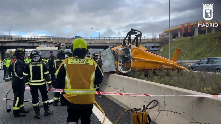 The mangled wreckage is cordoned off by emergency services on the M40 near Madrid