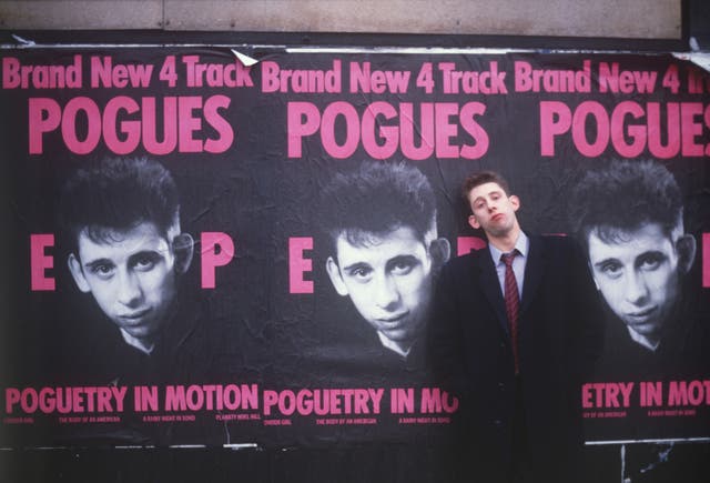 <p>The measure of our dreams: MacGowan by posters for 1986’s ‘Poguetry in Motion’ EP </p>