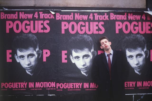 <p>The measure of our dreams: MacGowan by posters for 1986’s ‘Poguetry in Motion’ EP </p>