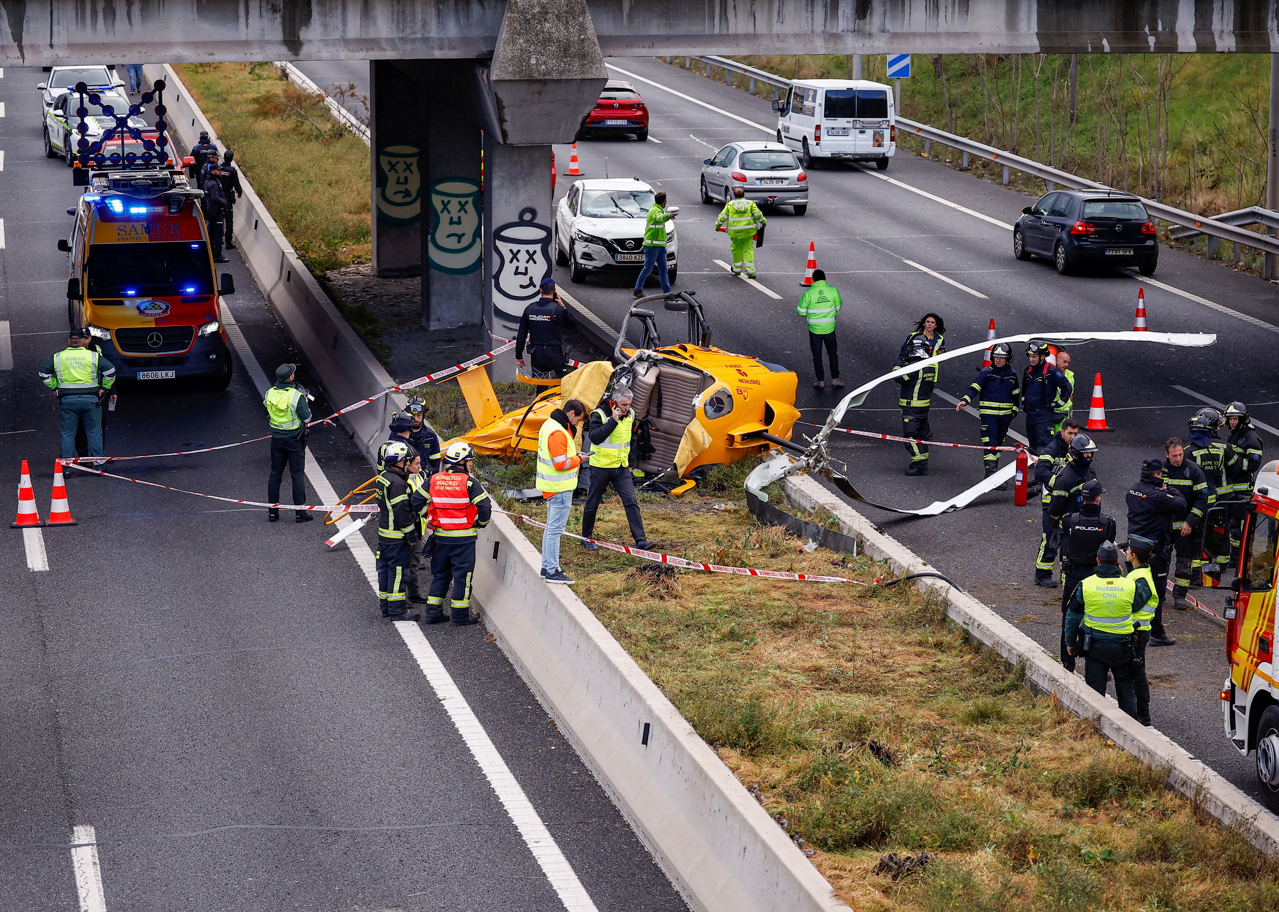 The helicopter’s mangled rotor blades lie across two motorway lanes