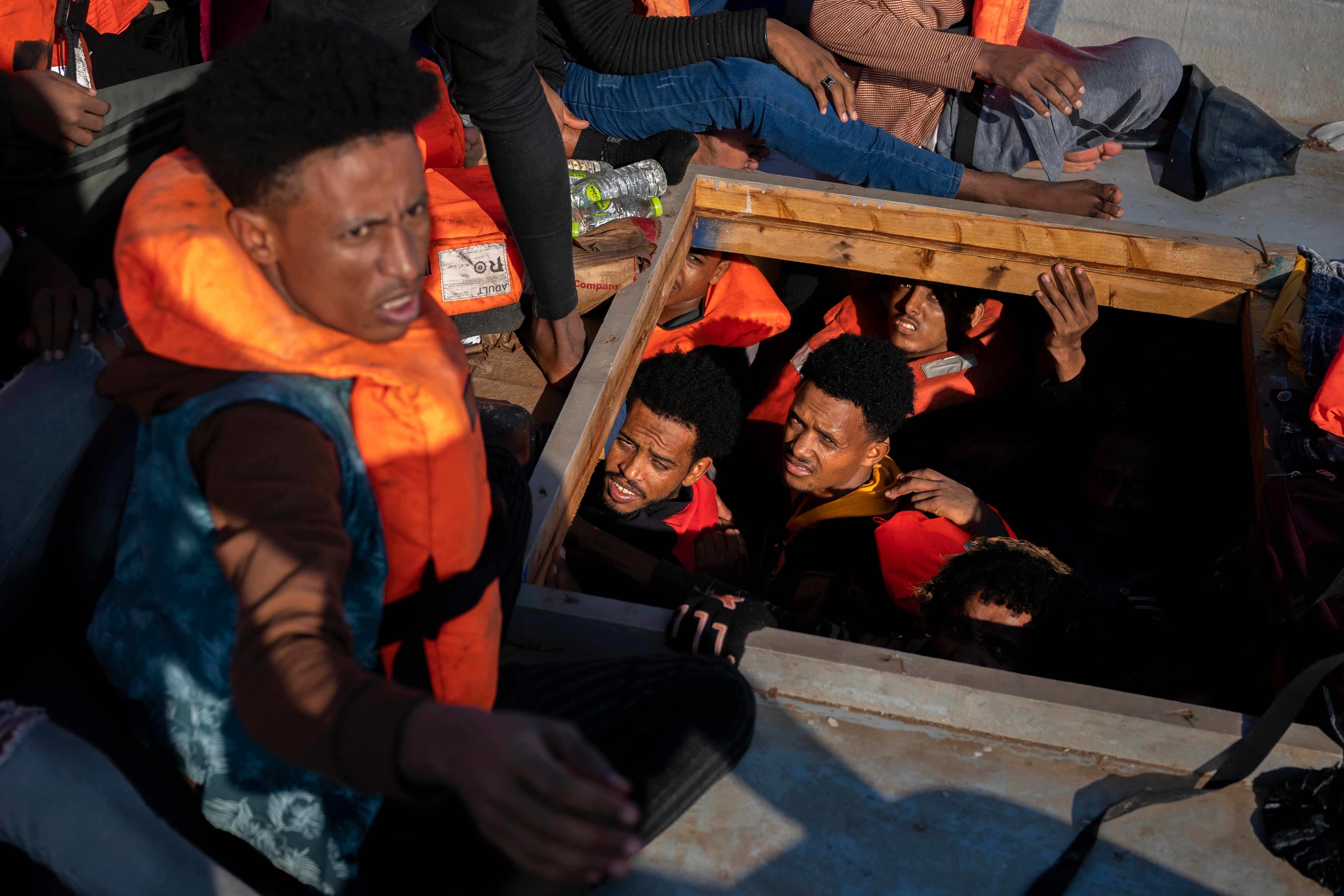 File image: Migrants from Eritrea, Libya and Sudan are crowded in the hold of a wooden boat before being assisted by aid workers