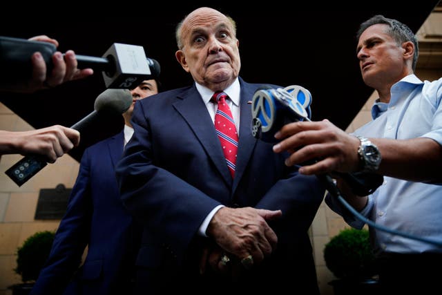 <p>Former Mayor of New York Rudy Giuliani speaks to reporters as he leaves his apartment building in New York in August </p>