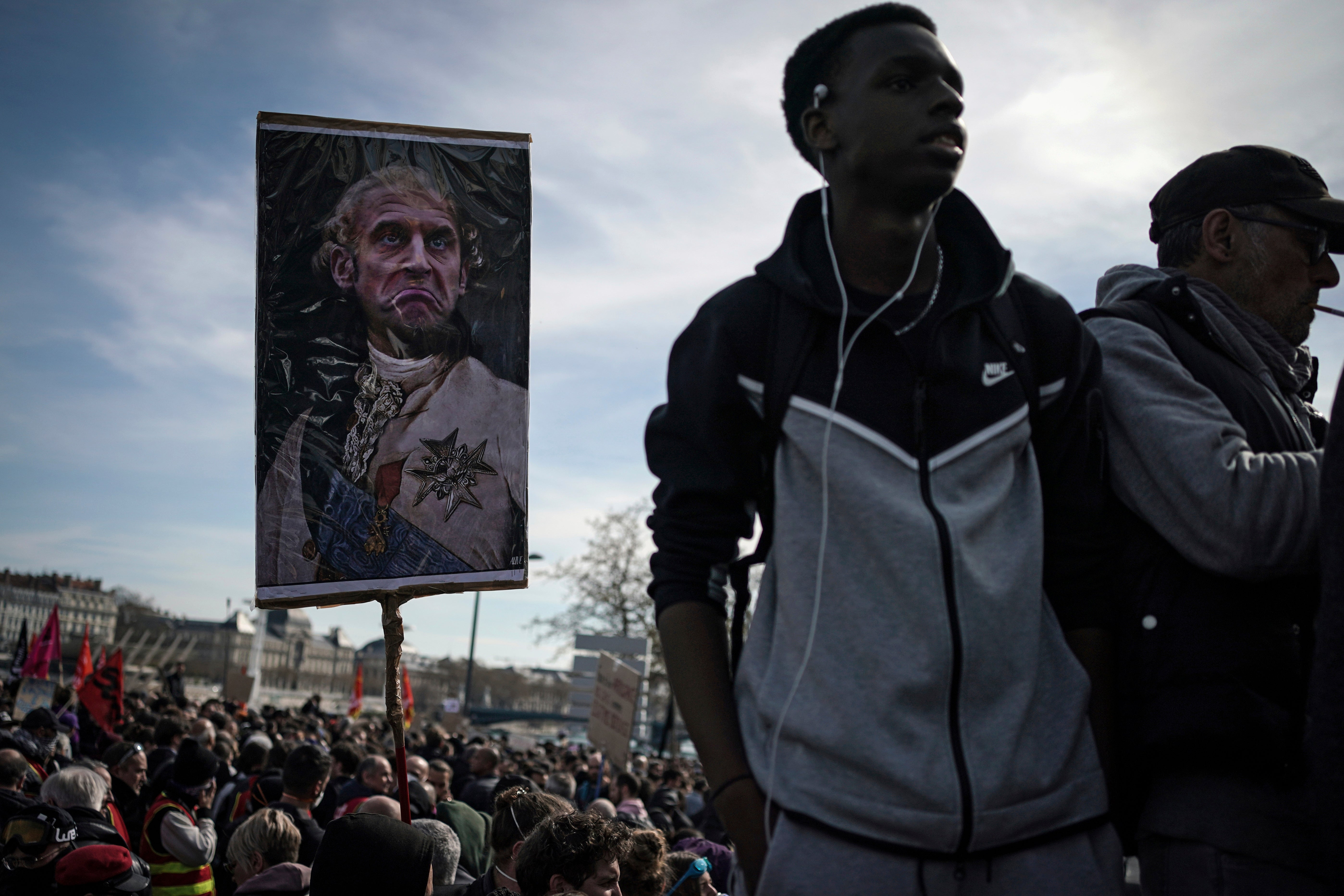 A guard has placed a picture of Emmanuel Macron dressed as a king during a demonstration against unpopular pension reforms in 2023.