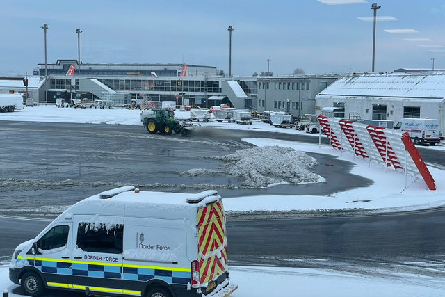 <p>A plough clears the runway at Glasgow airport after heavy snow</p>