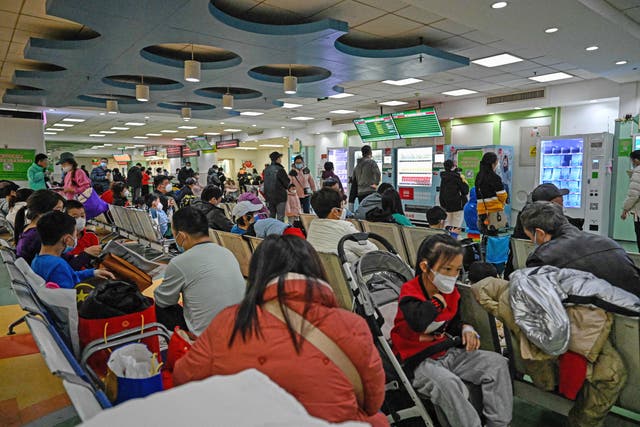 <p>File: Children and their parents wait at an outpatient area at a children hospital in Beijing on 23 November </p>