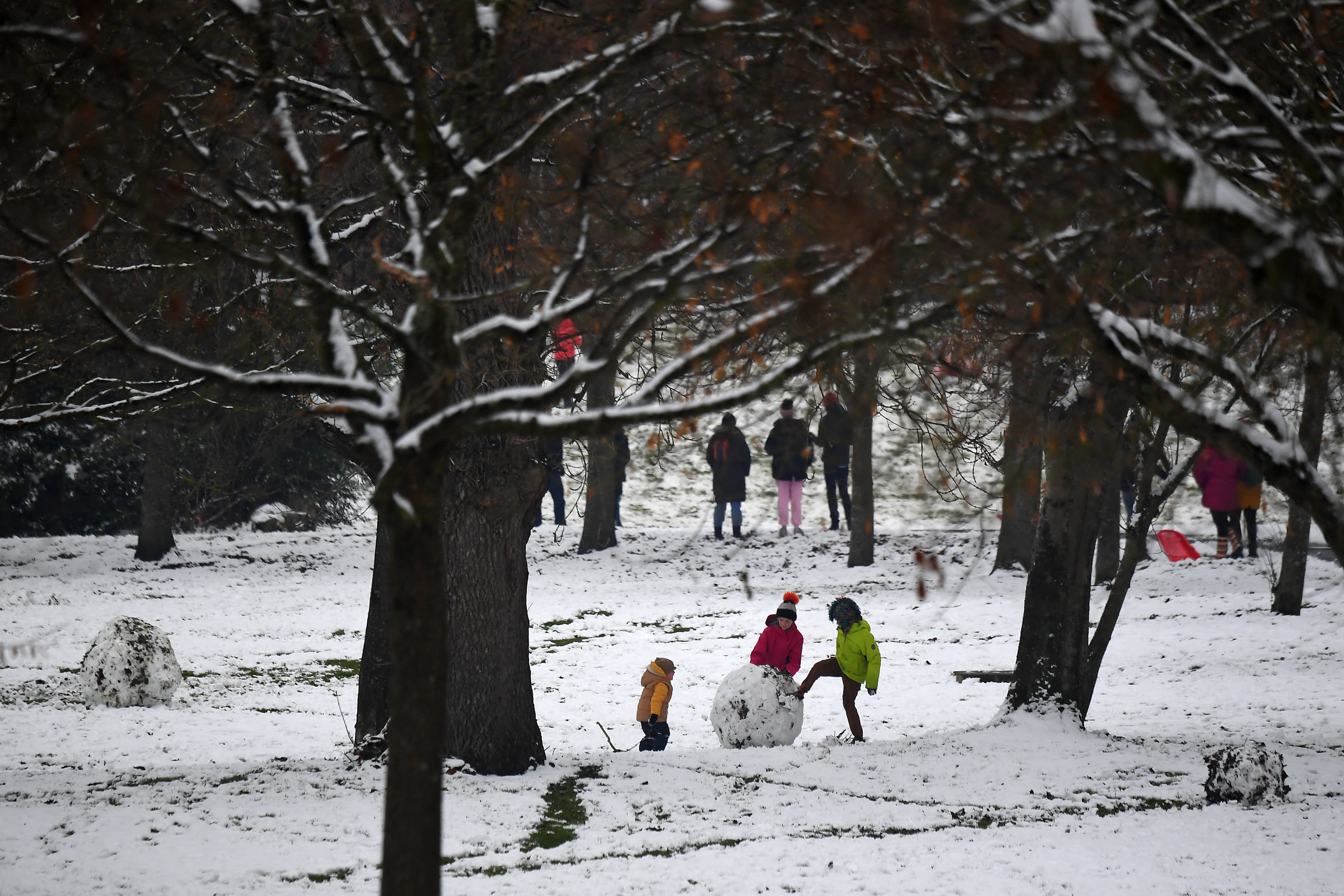 Children play in the snow in Glasgow’s Victoria Park