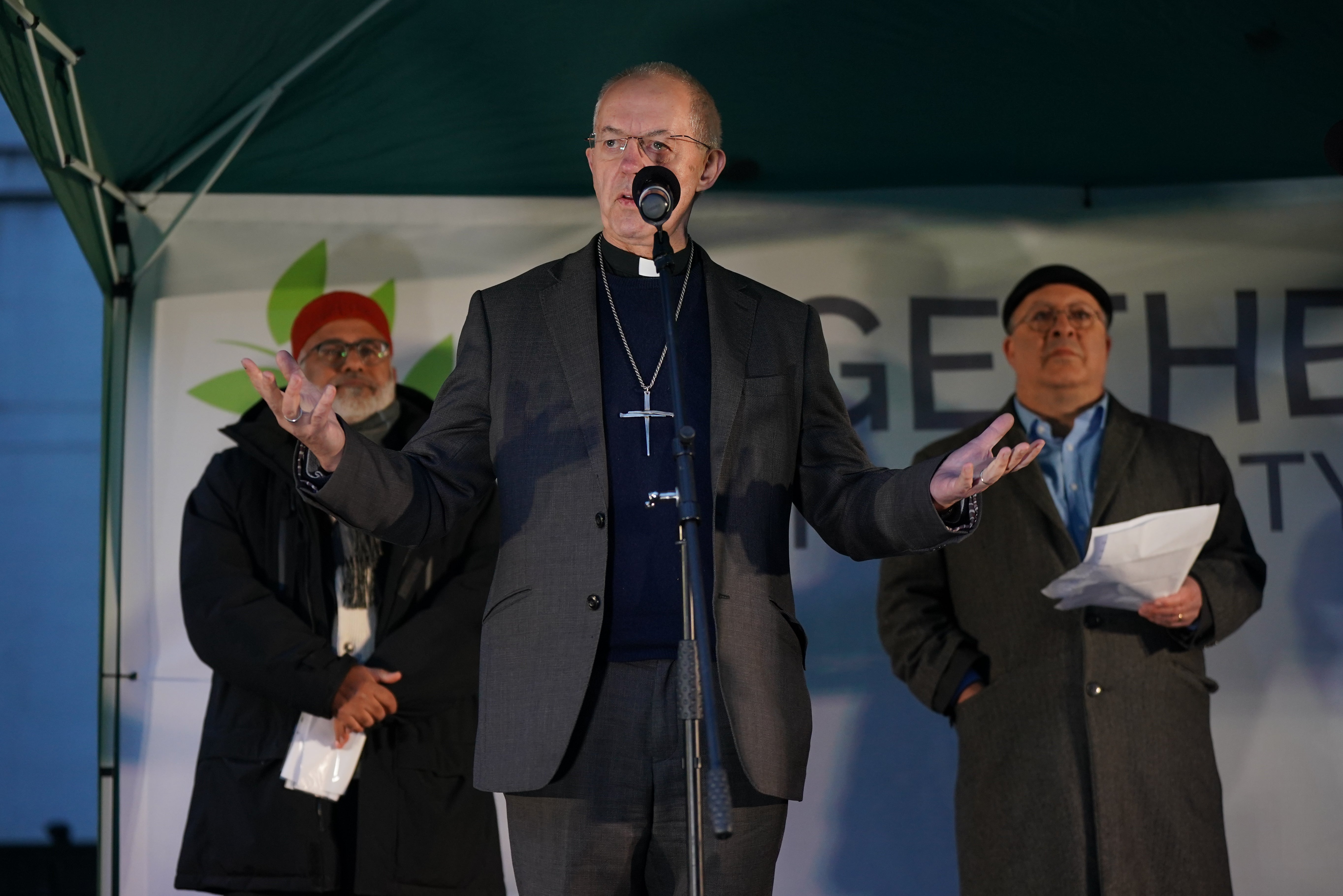 Imam Monawar Hussain (left) and Rabbi David Mason listen to listen to Justin Welby address the vigil on Richmond Terrace