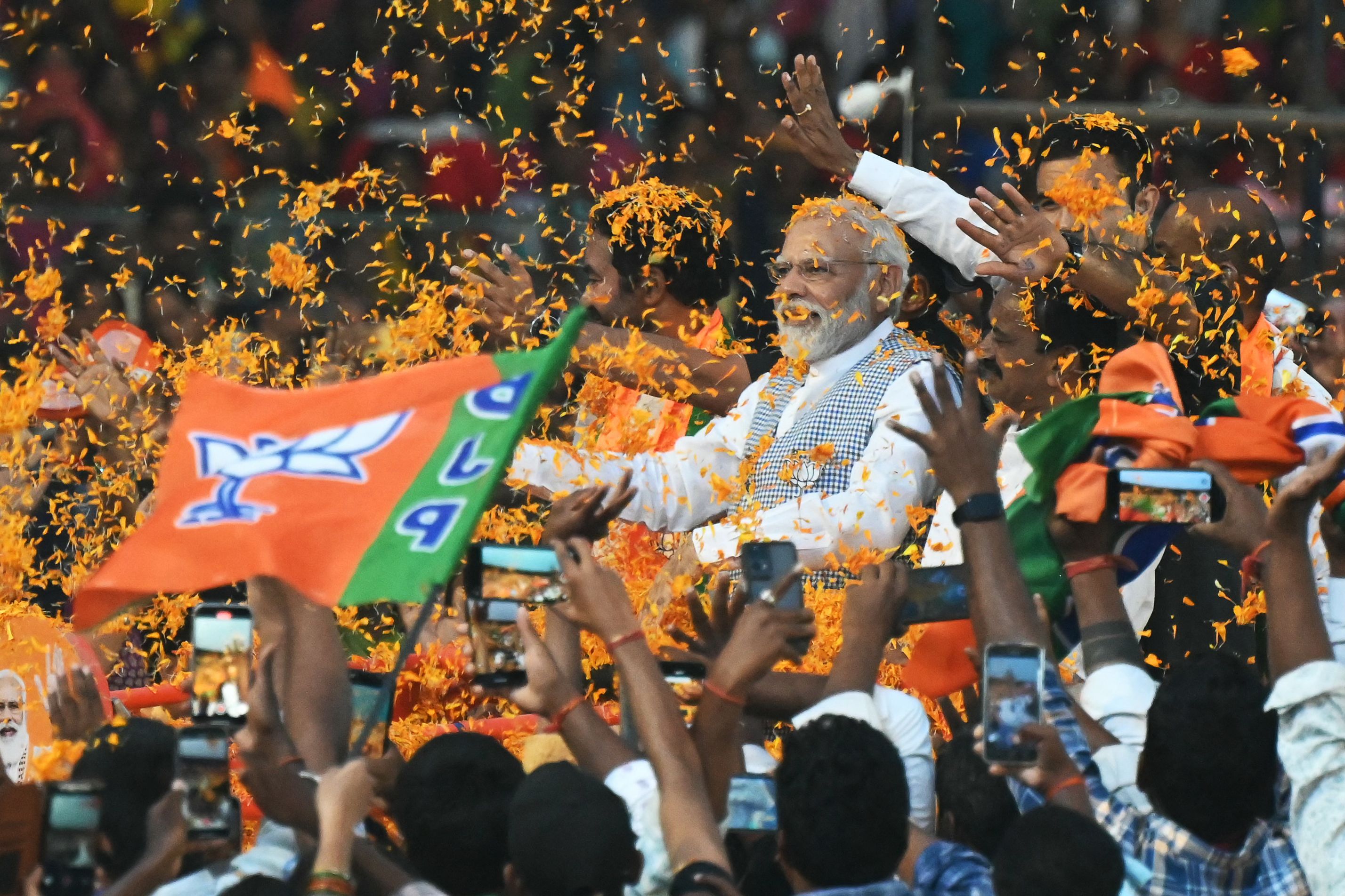 File: Indian prime minister Narendra Modi (C) arrives to attend a Bharatiya Janata Party (BJP) campaign meeting