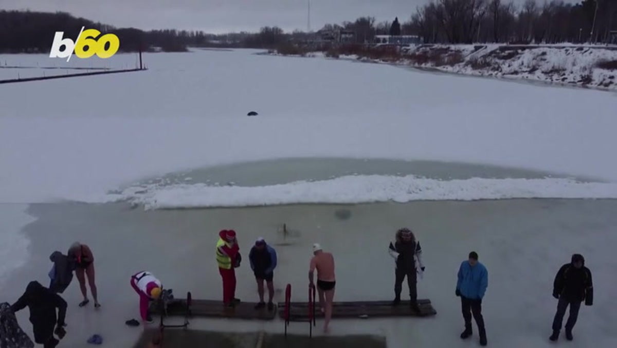 Swimmers race in frozen lake to welcome winter in Siberia