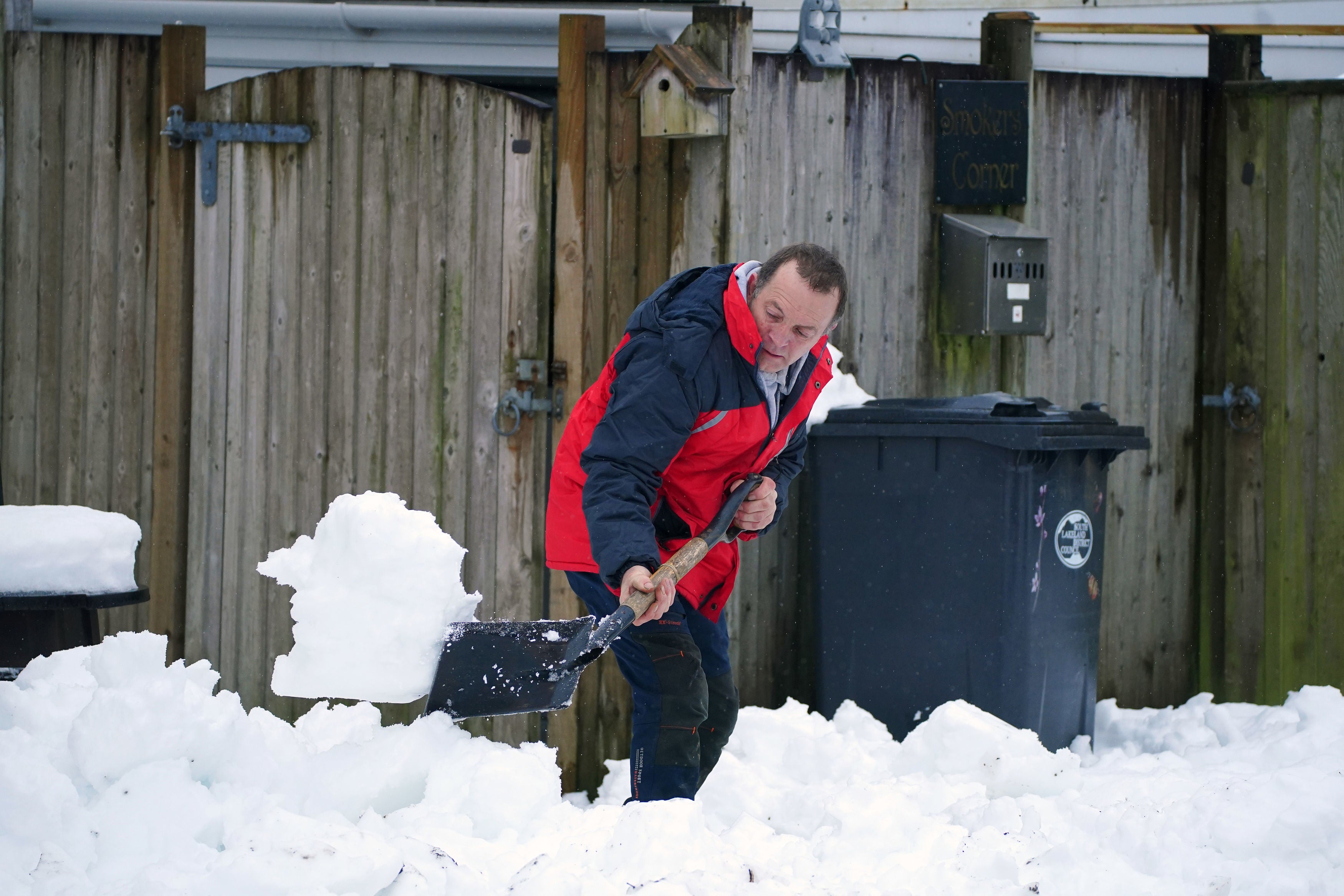 Shoveling snow in Ings, Cumbria. More than 830 properties in the county were still without power after heavy weekend snow