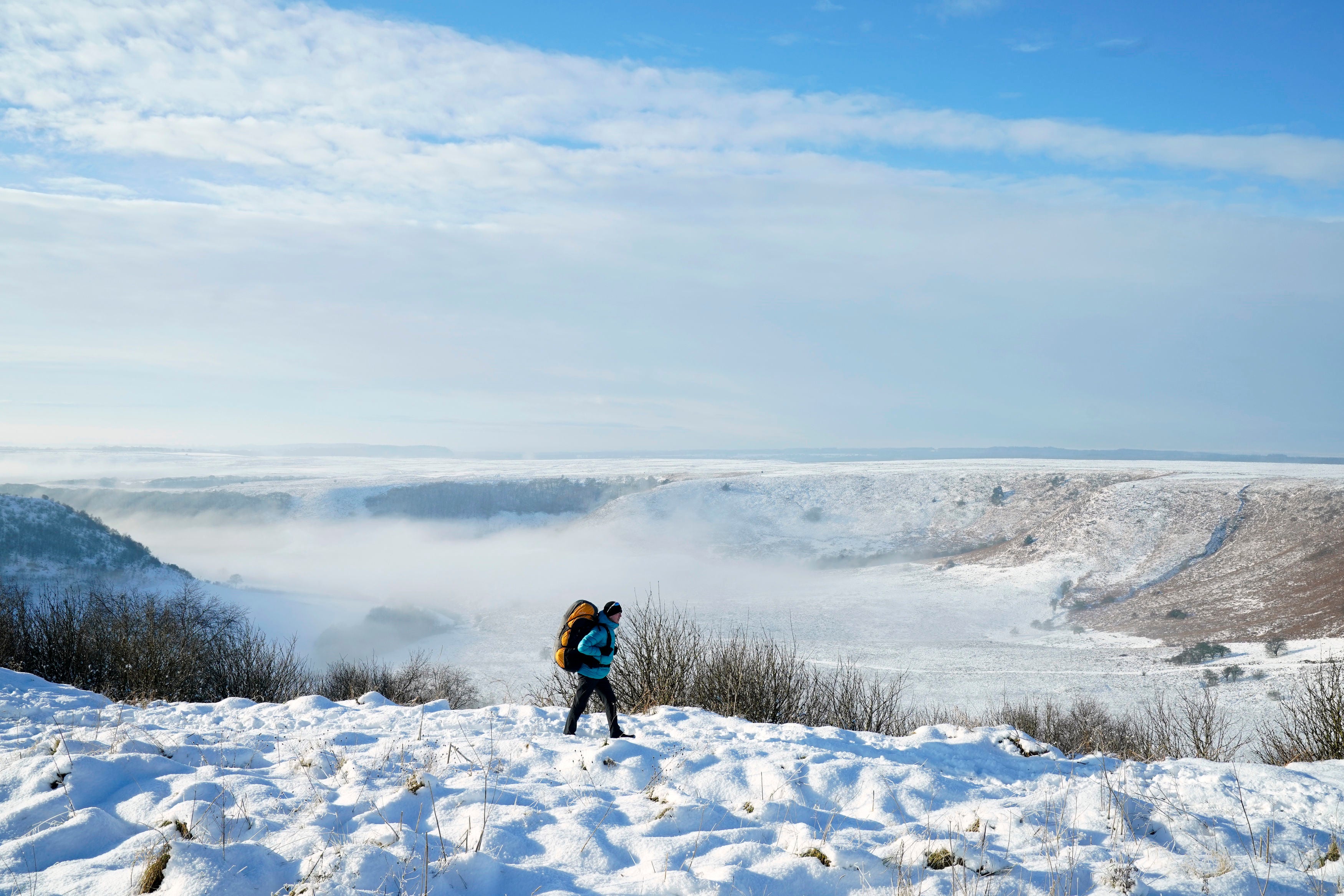 Walking through snow above the Hole of Horcum at the North York Moors National Park