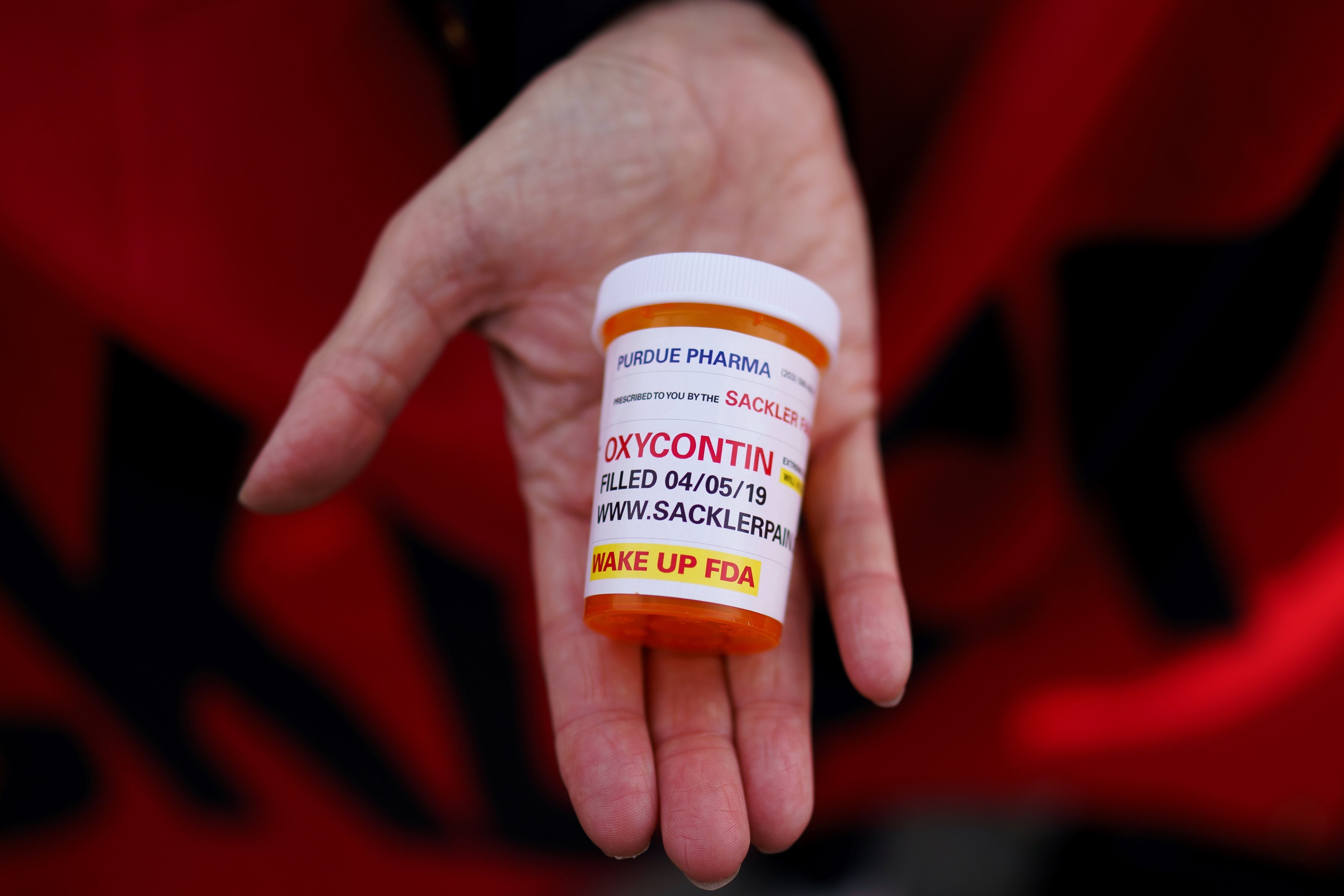 A campaigner holds a pill container outside the US Supreme Court