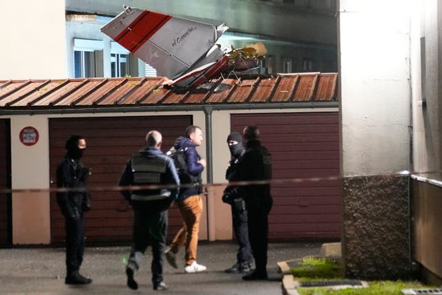 <p>Police officers stand by the tail of a small plane that made an emergency landing in Paris on Monday </p>
