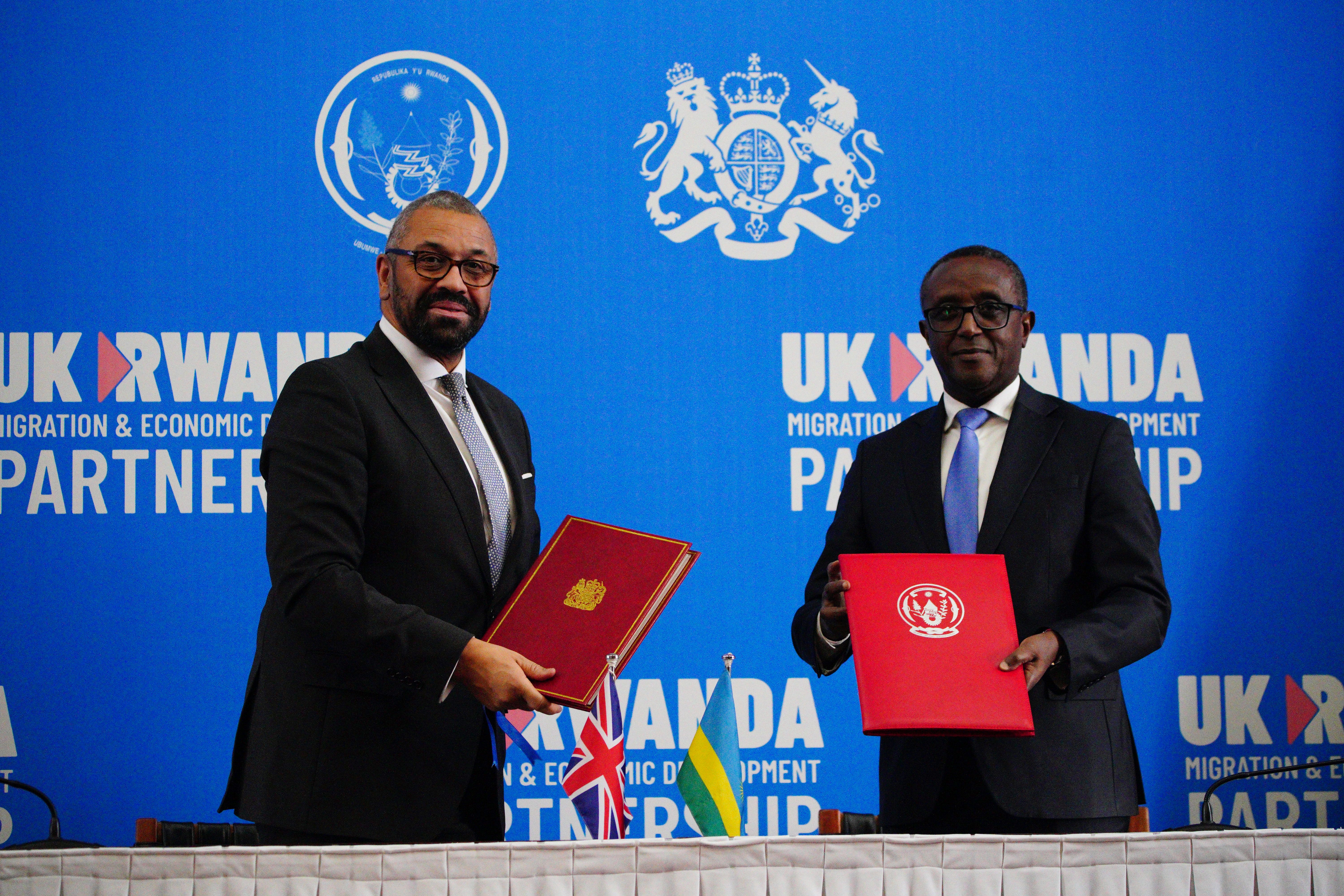 Home Secretary James Cleverly and Rwandan Minister of Foreign Affairs Vincent Biruta sign the new treaty (Ben Birchall/PA)