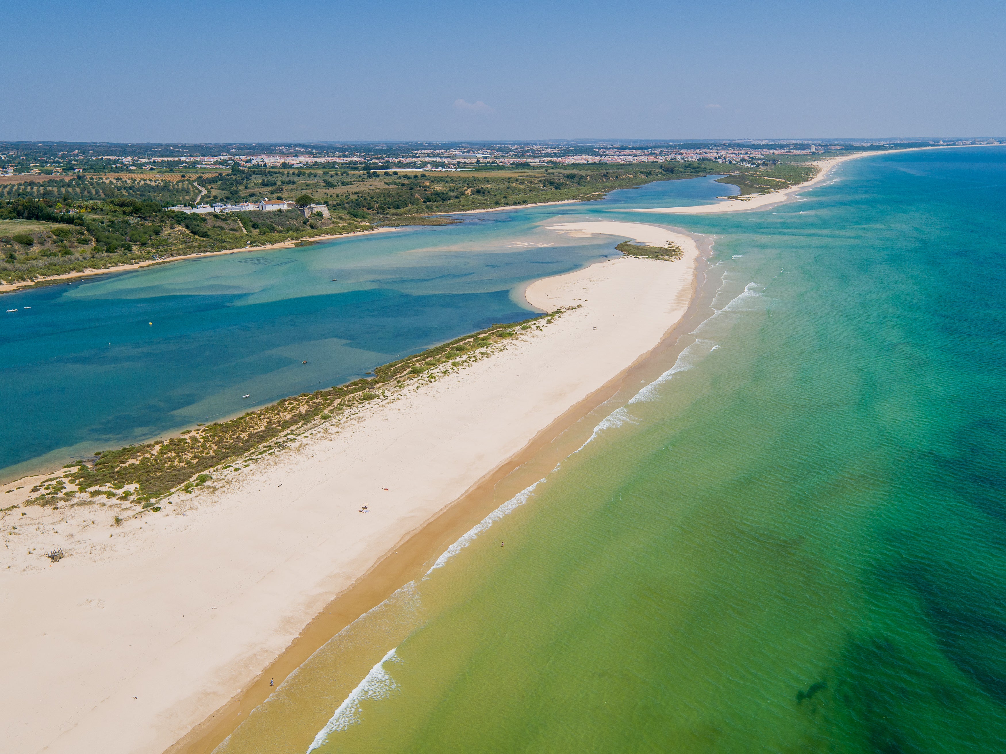 Enjoy a stroll, paddle or swim at sunset on this stunning bow-shaped beach