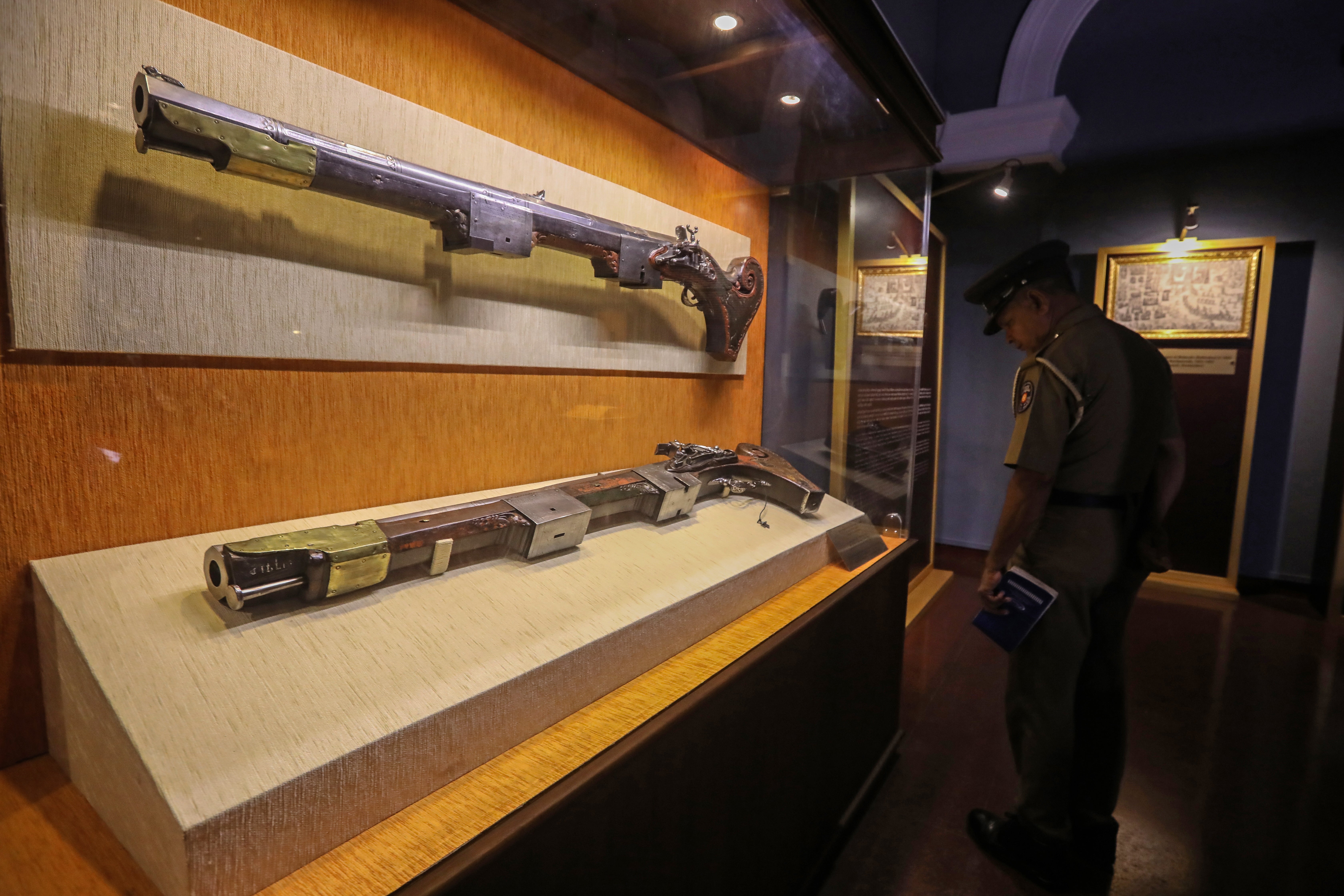 A Sri Lankan officer looks at 'Maha Thuwakkuwa', the unique guns of the Singhalese, which were returned by the Netherlands