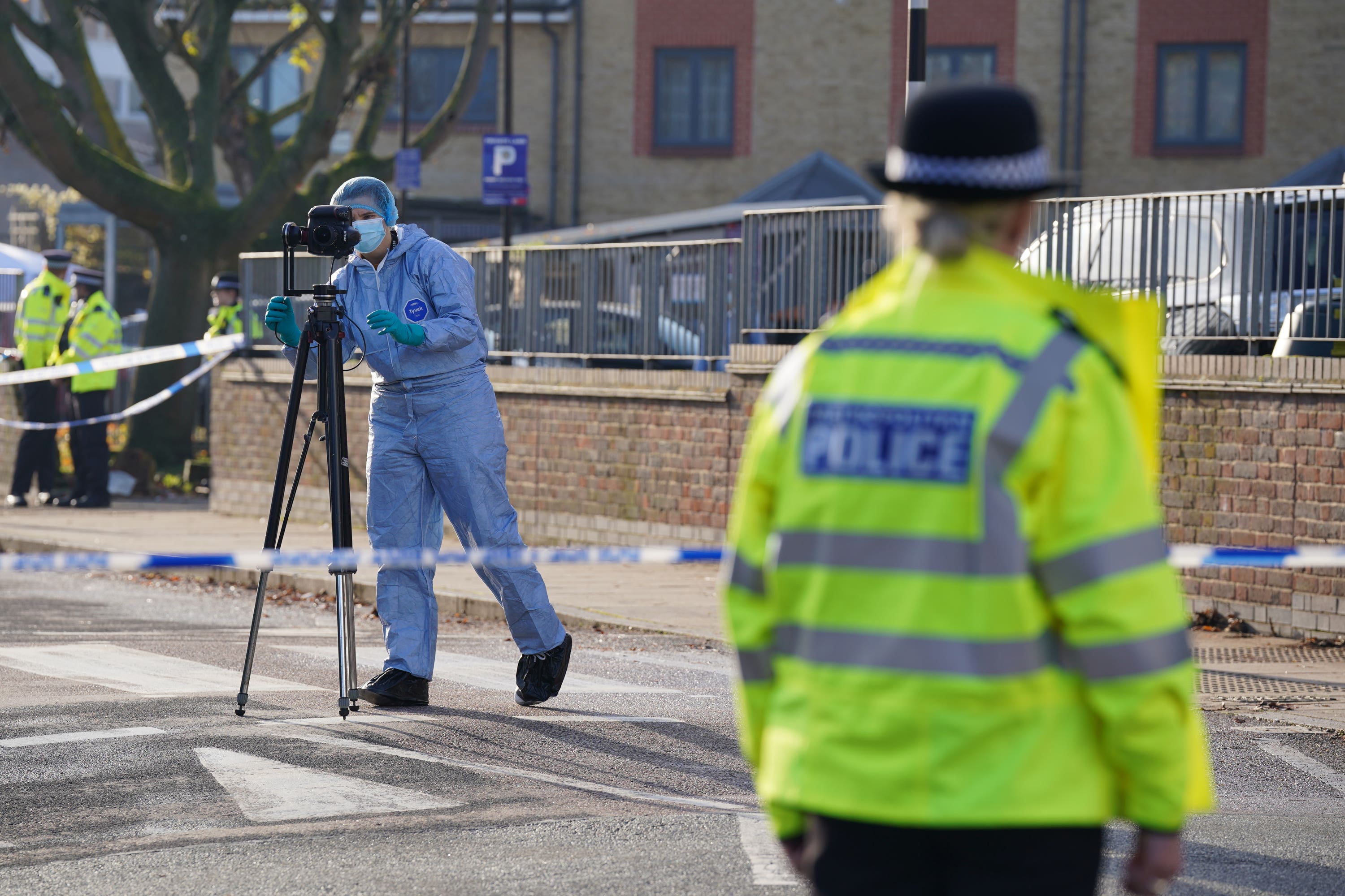 Police at the scene of the fatal shooting in Vine Close, Hackney