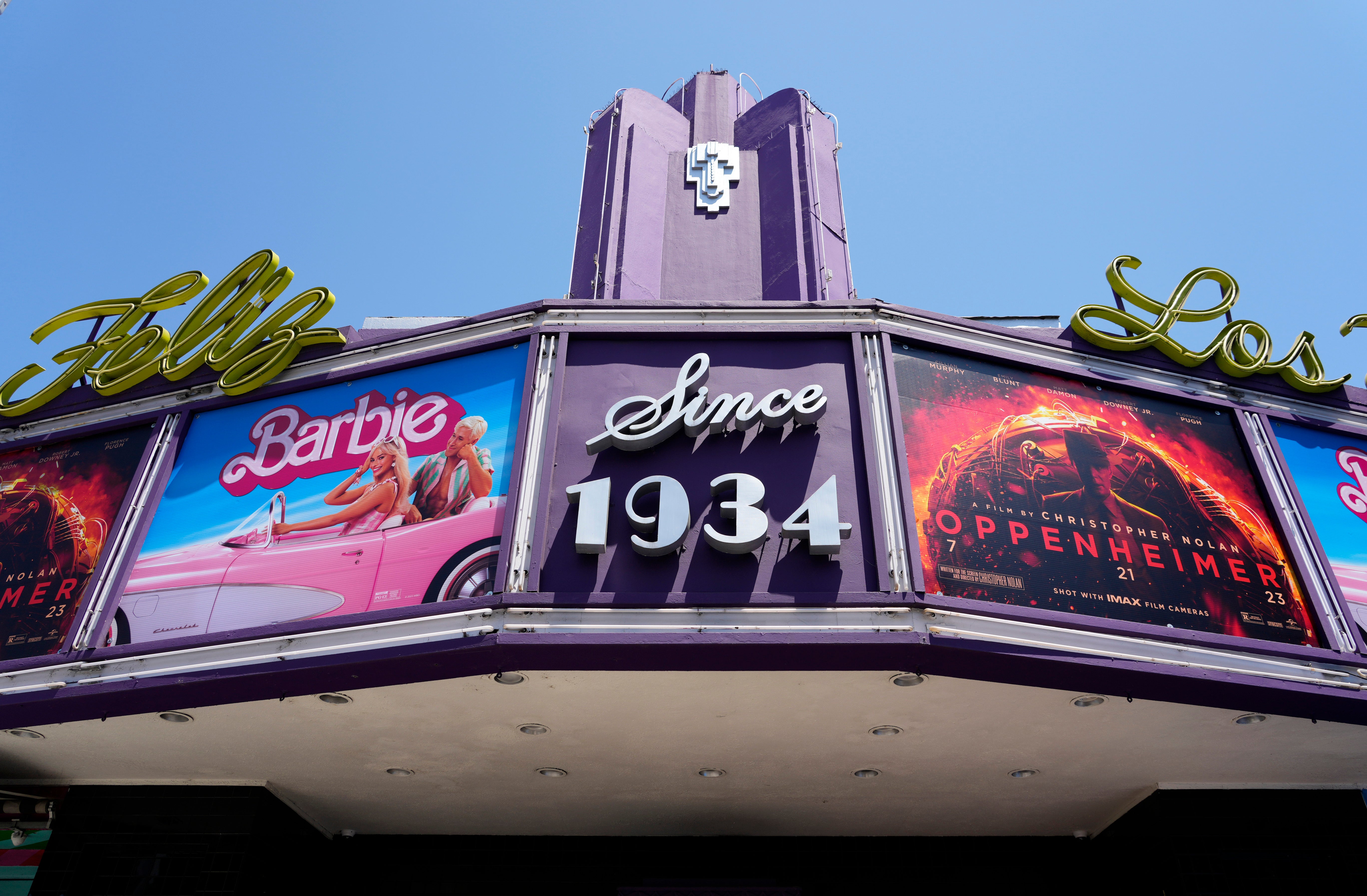 The marquee of the Los Feliz Theatre features the films Barbie and Oppenheimer in July 2023