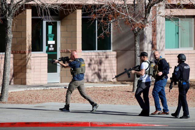 <p>Law enforcement officers head into the campus of the University of Nevada, Las Vegas, after reports of an active shooter</p>