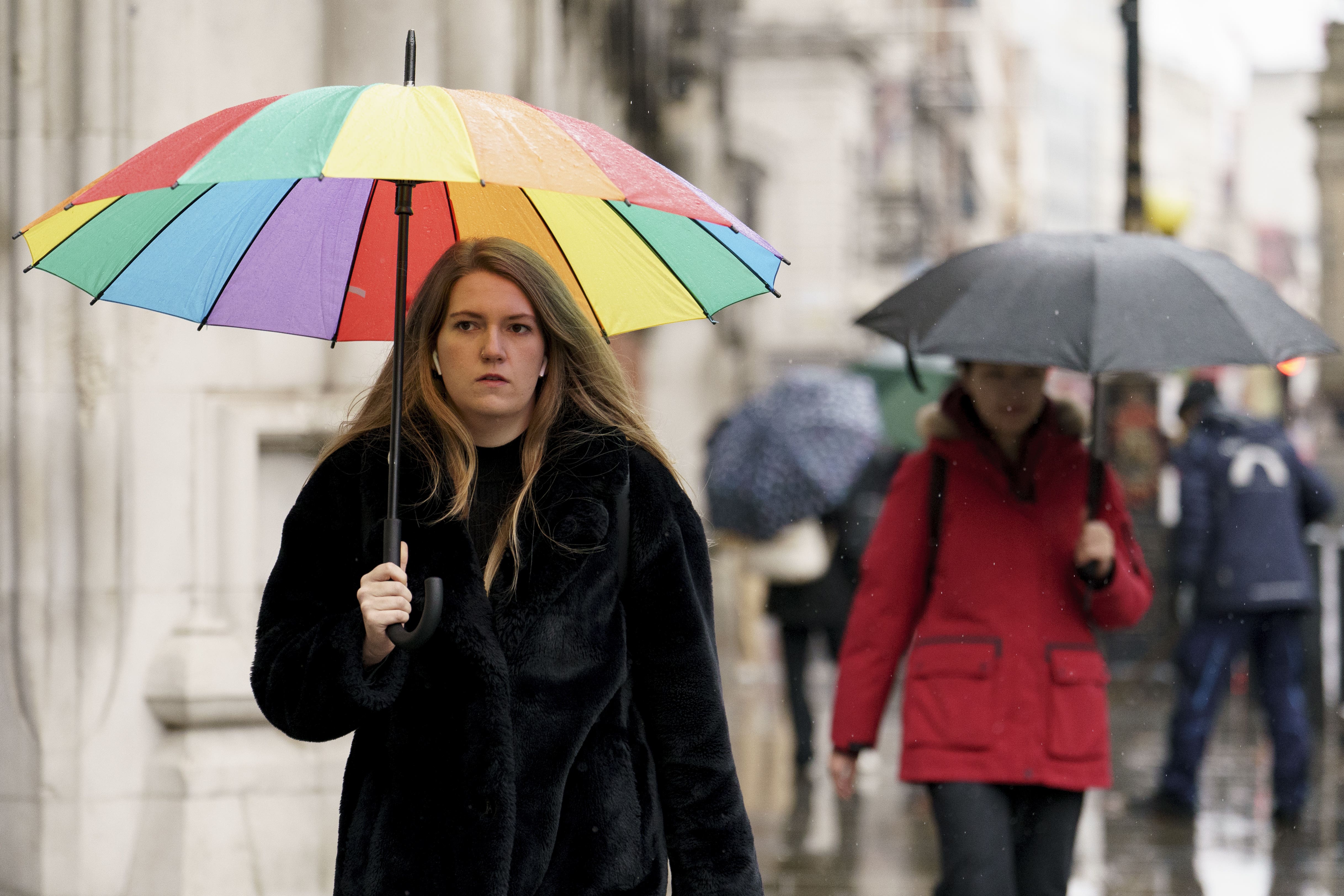 Members of the public shelter from the rain