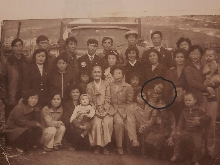 North Korean sisters Kim Cheol-ok (in circle) seen with her family, resting her hand on her sister Kim Kyu. Kyu is now searching for her sister Cheol-ok after reports of forcible deportation to North Korea by China