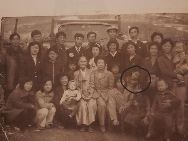 <p>North Korean sisters Kim Cheol-ok (in circle) seen with her family, resting her hand on her sister Kim Kyu. Kyu is now searching for her sister Cheol-ok after reports of forcible deportation to North Korea by China </p>