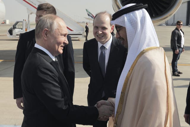 <p>Vladimir Putin shakes hands with UAE foreign minister Sheikh Abdullah Bin Zayed upon arrival at the airport in Abu Dhabi</p>