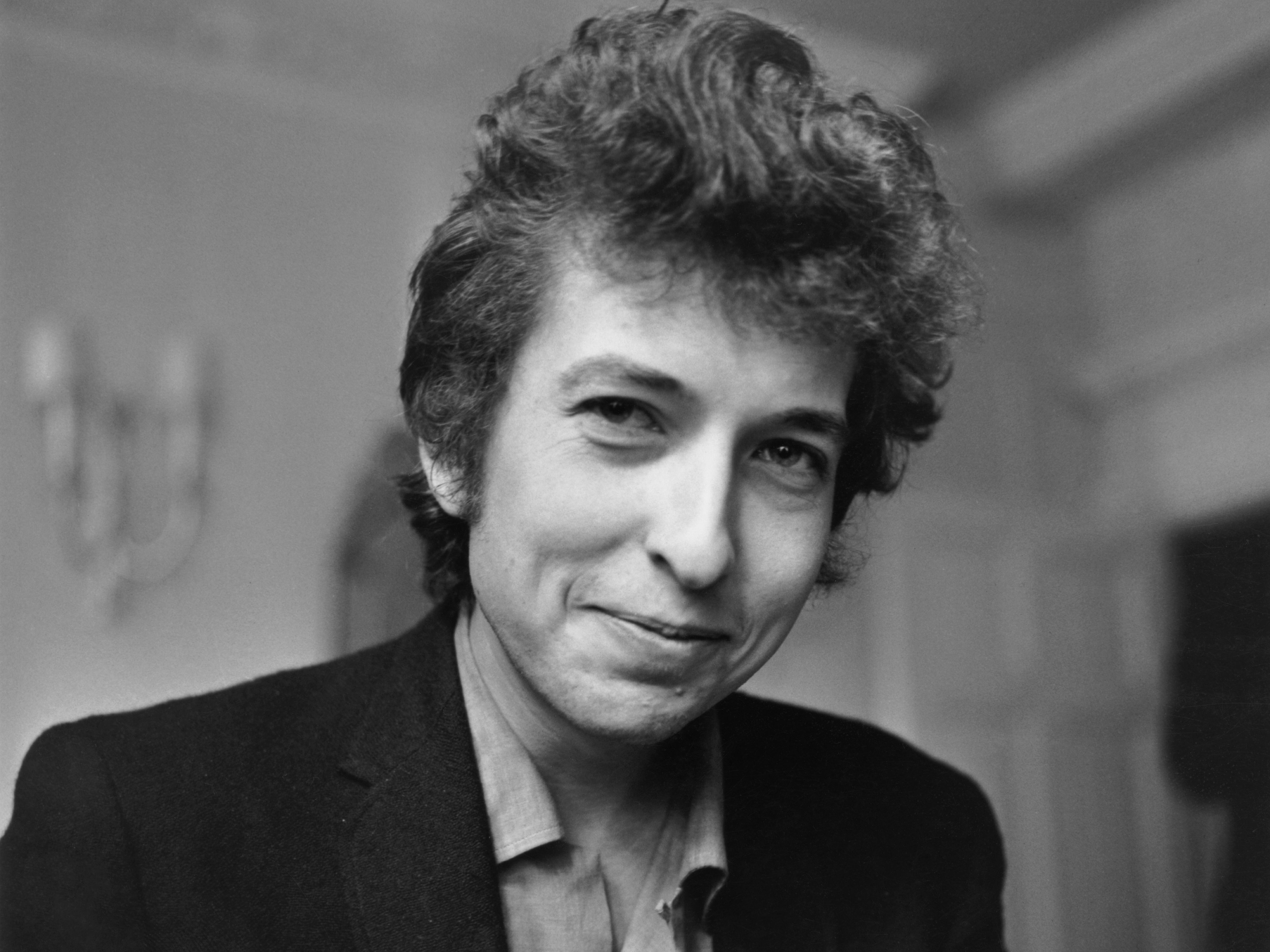 Bob Dylan flashes a rare smile during a meeting with the British press on 28 April 1965