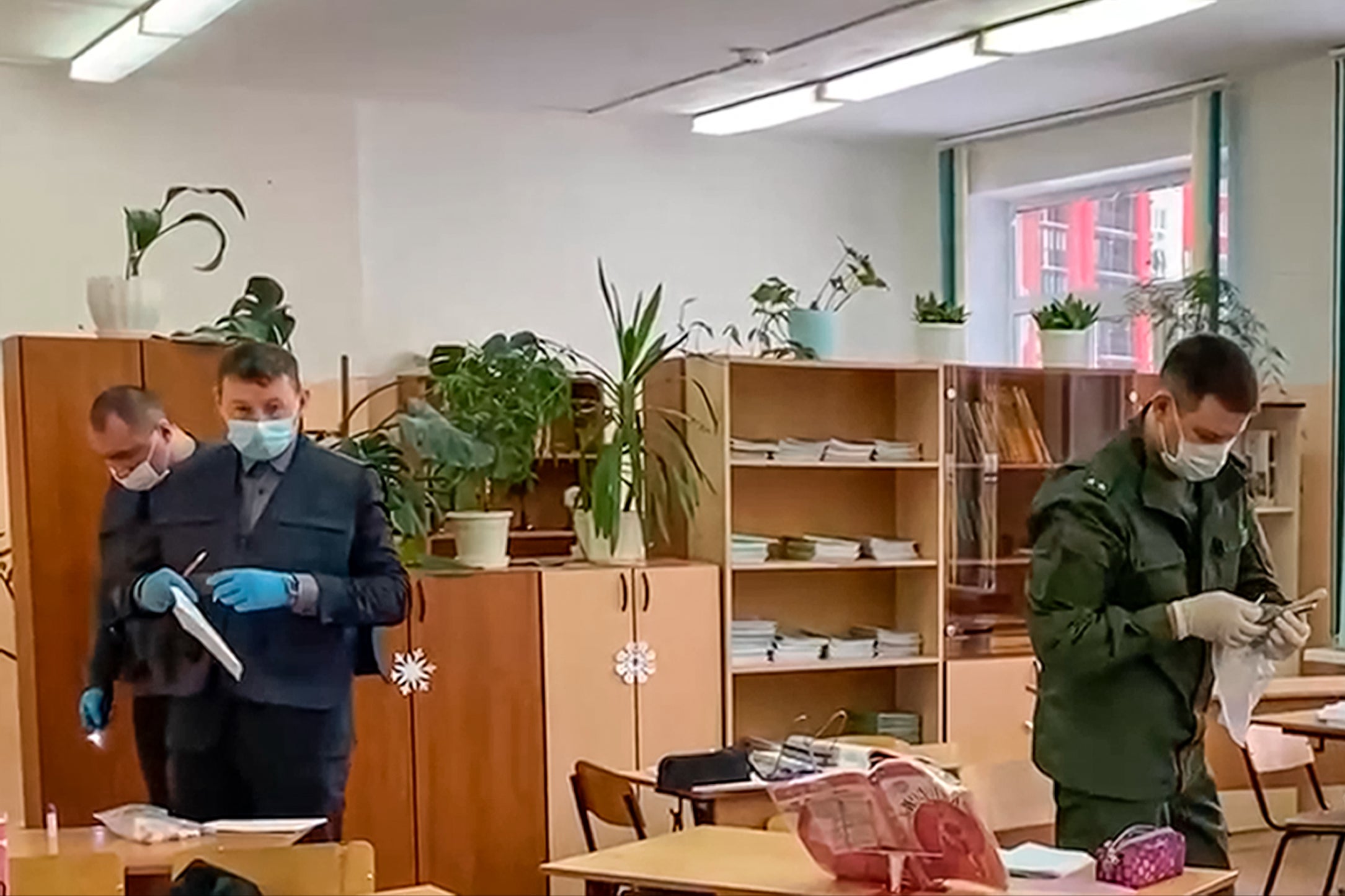 Investigators work at the scene of a shooting in a school classroom in Bryansk, Russia