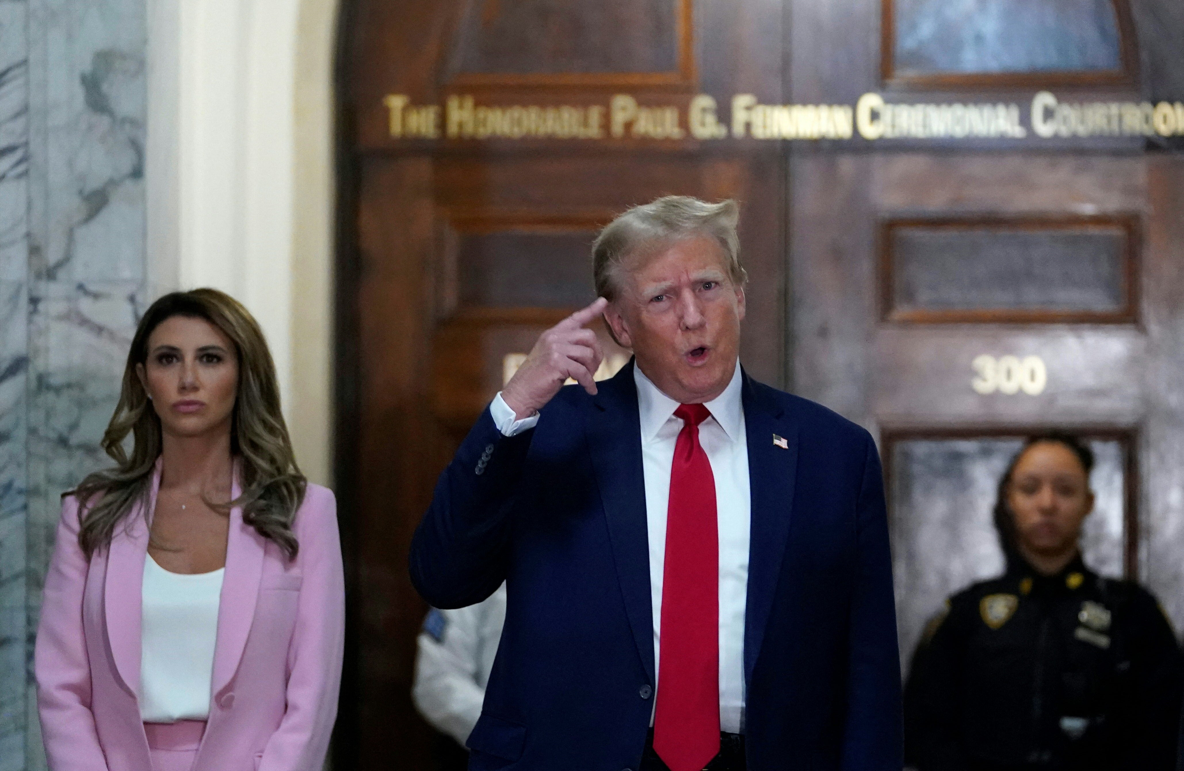 Donald Trump speaks to reporters alongside his attorney Alina Habba, left, outside Judge Arthur Engoron’s courtroom in New York County Supreme Court on 7 December