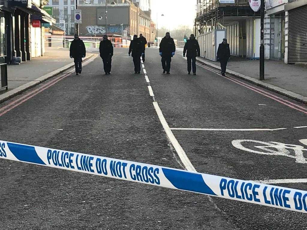 Police scour the scene of Sutton stabbing