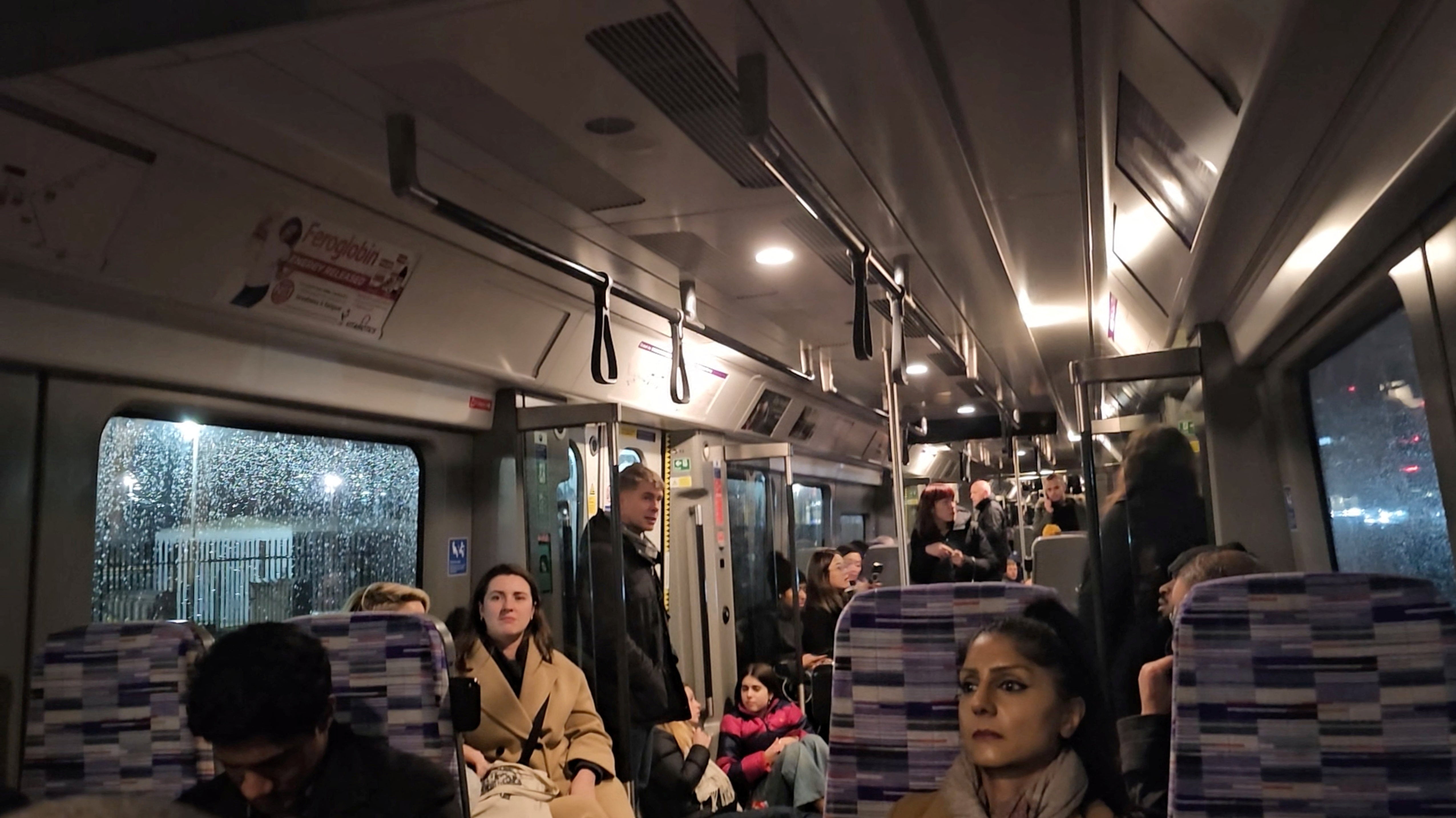 Passengers wait inside a train stuck on the Elizabeth Line