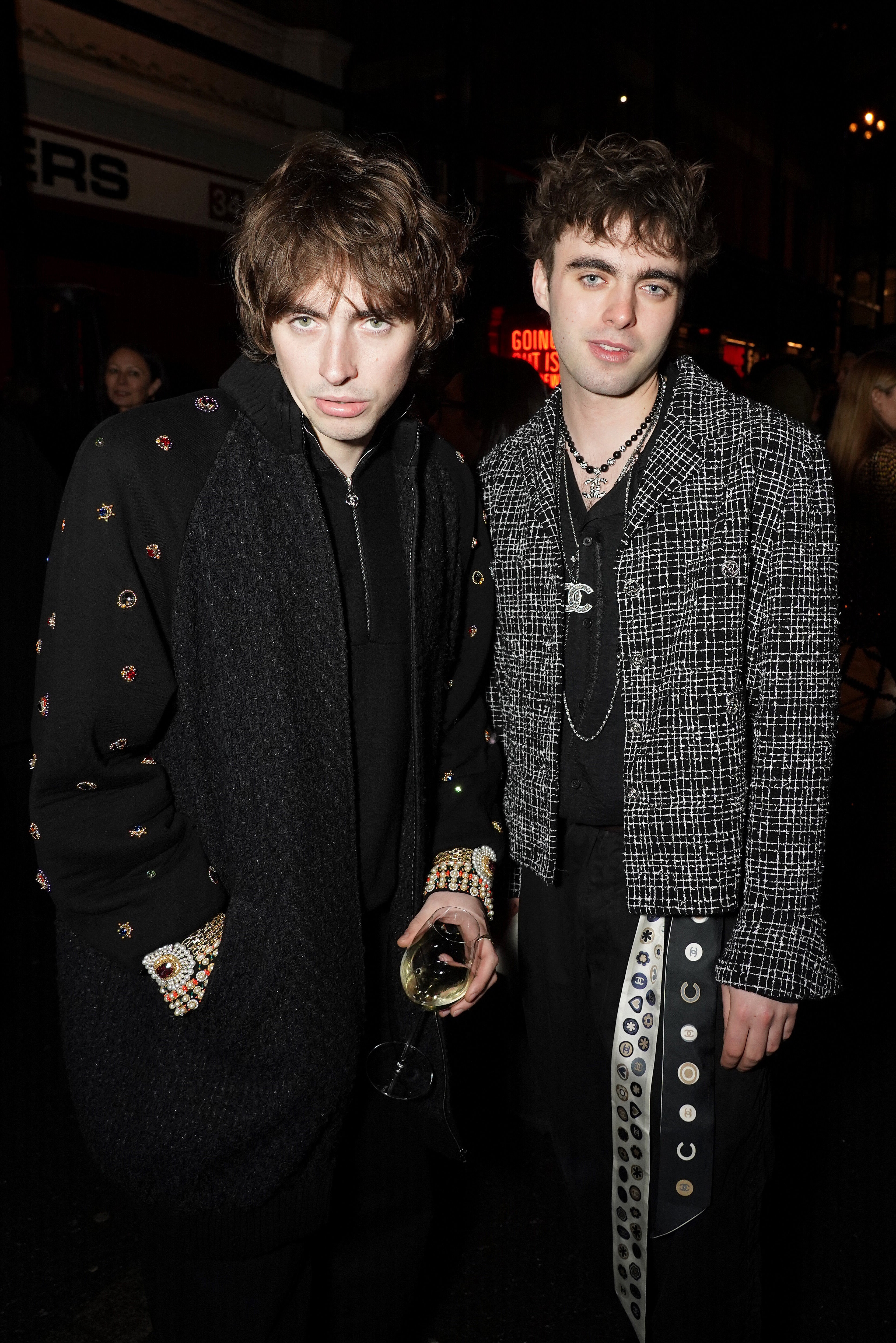 Gene Gallagher and Lennon Gallagher wear Chanel at the Metiers D'Art Show