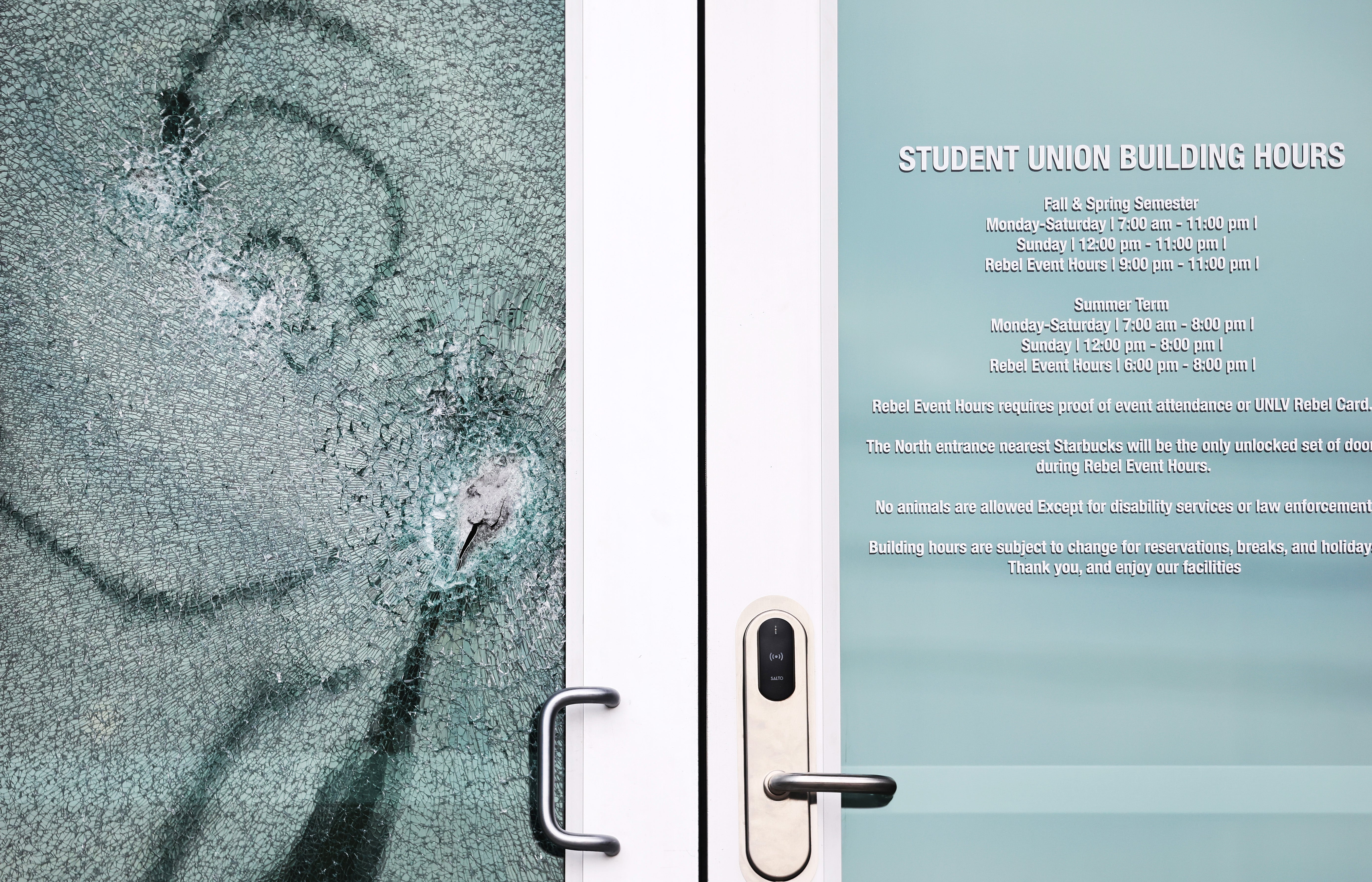 A shattered door is viewed at the student union building the morning after a shooting left three dead at the University of Nevada