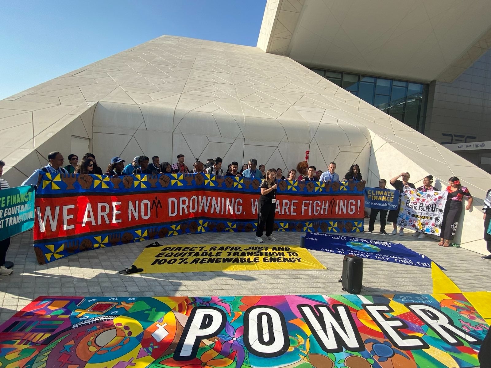 Climate activists at the Cop28 venue in Dubai, United Arab Emirates on Friday