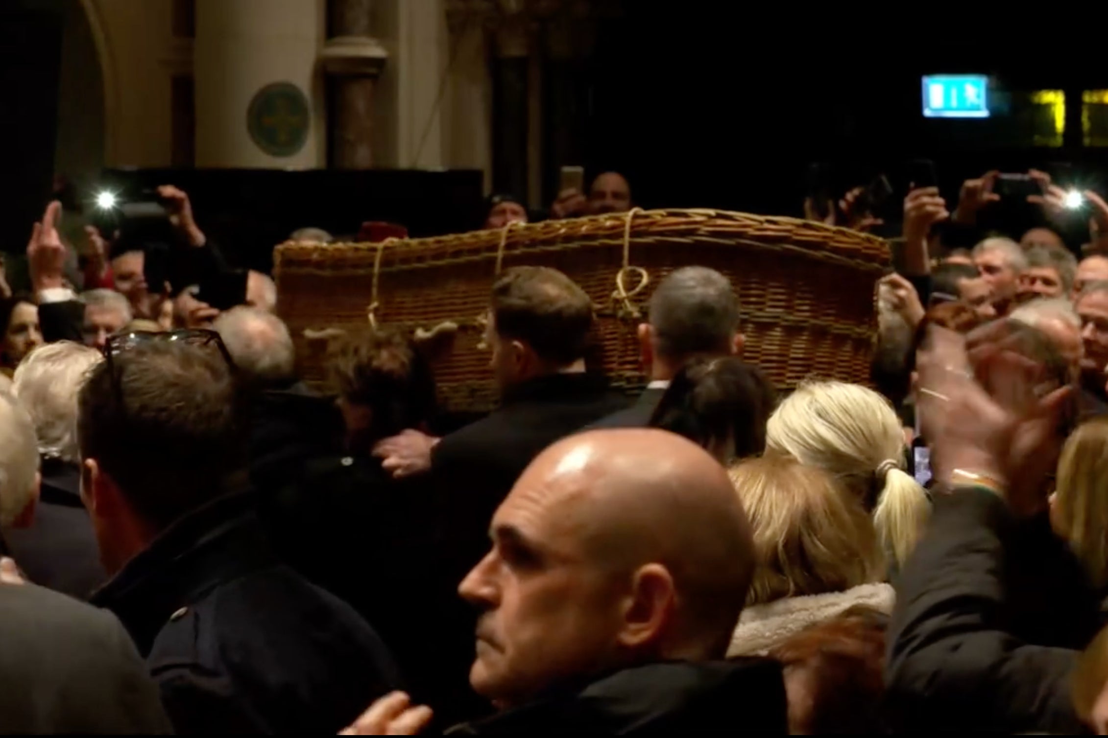 Shane MacGowan’s wicker casket leaves the church