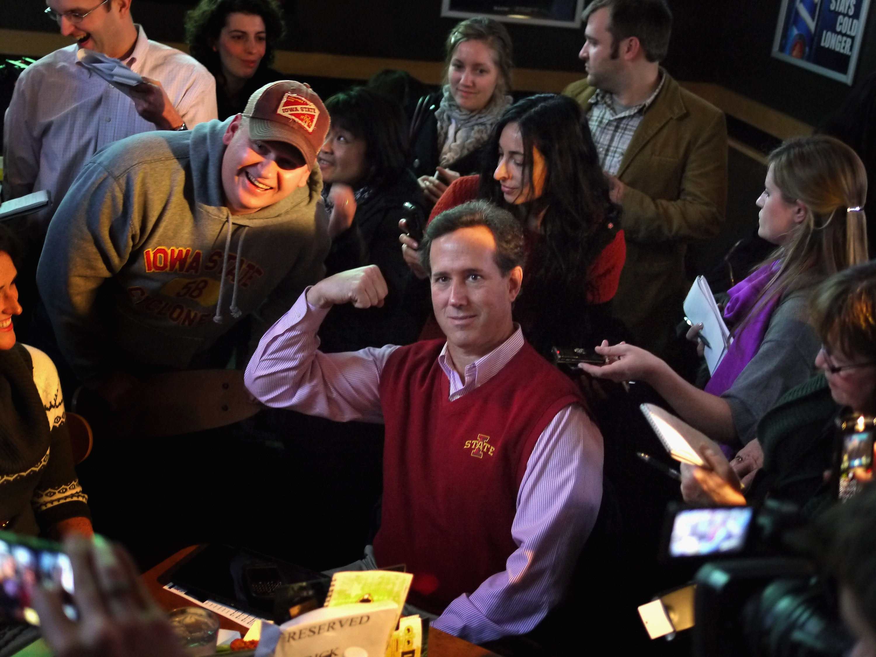 Republican presidential candidate former U.S. Senator Rick Santorum (R-PA) poses for a picture while hosting a Pinstripe Bowl watch party at Buffalo Wild Wings Grill and Bar on December 30, 2011, in Ames, Iowa