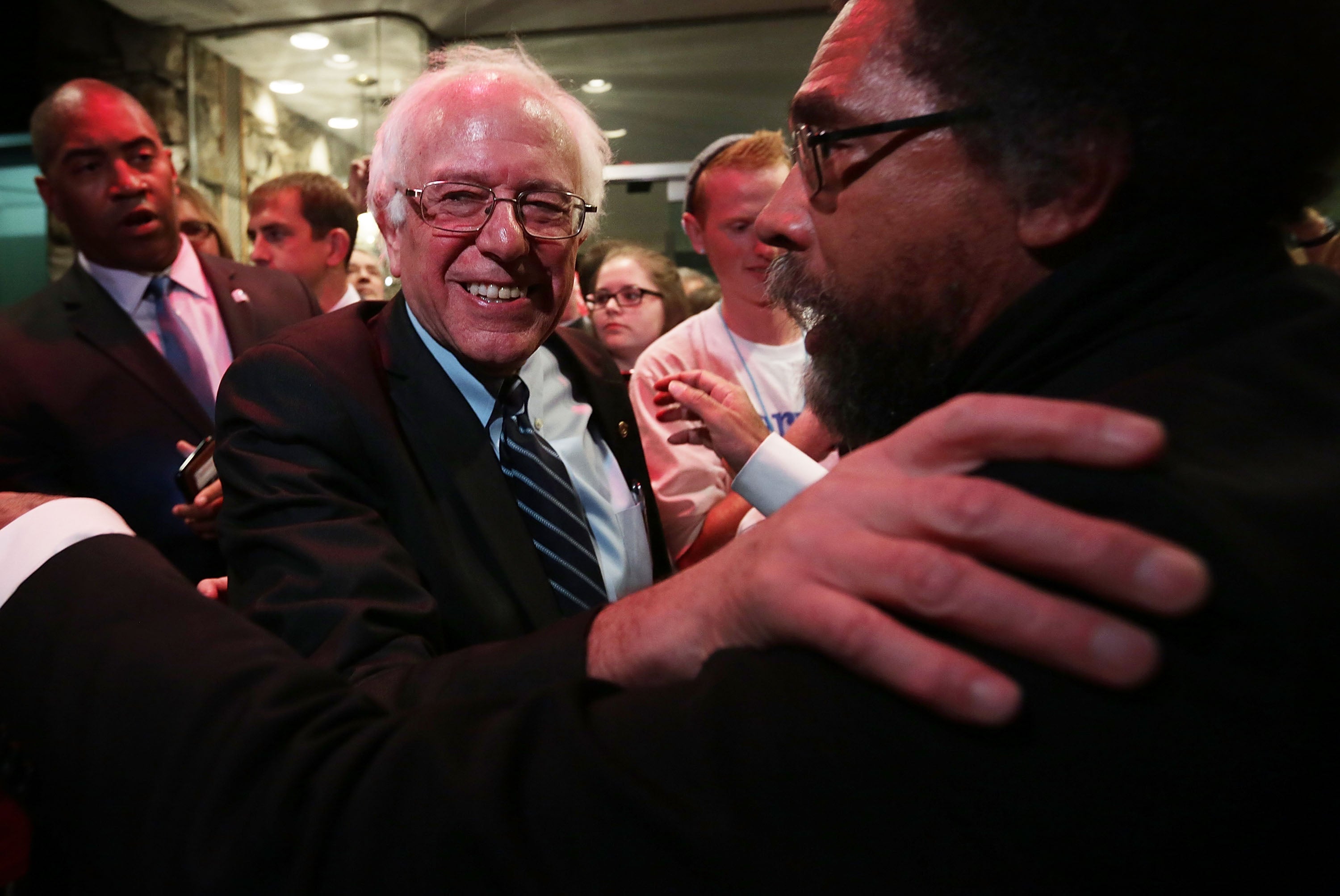 Philosopher Cornel West, right, embraces Democratic presidential candidate Sen. Bernie Sanders (I-VT) at a watch party for the second Democratic presidential debate November 14, 2015, in Des Moines, Iowa