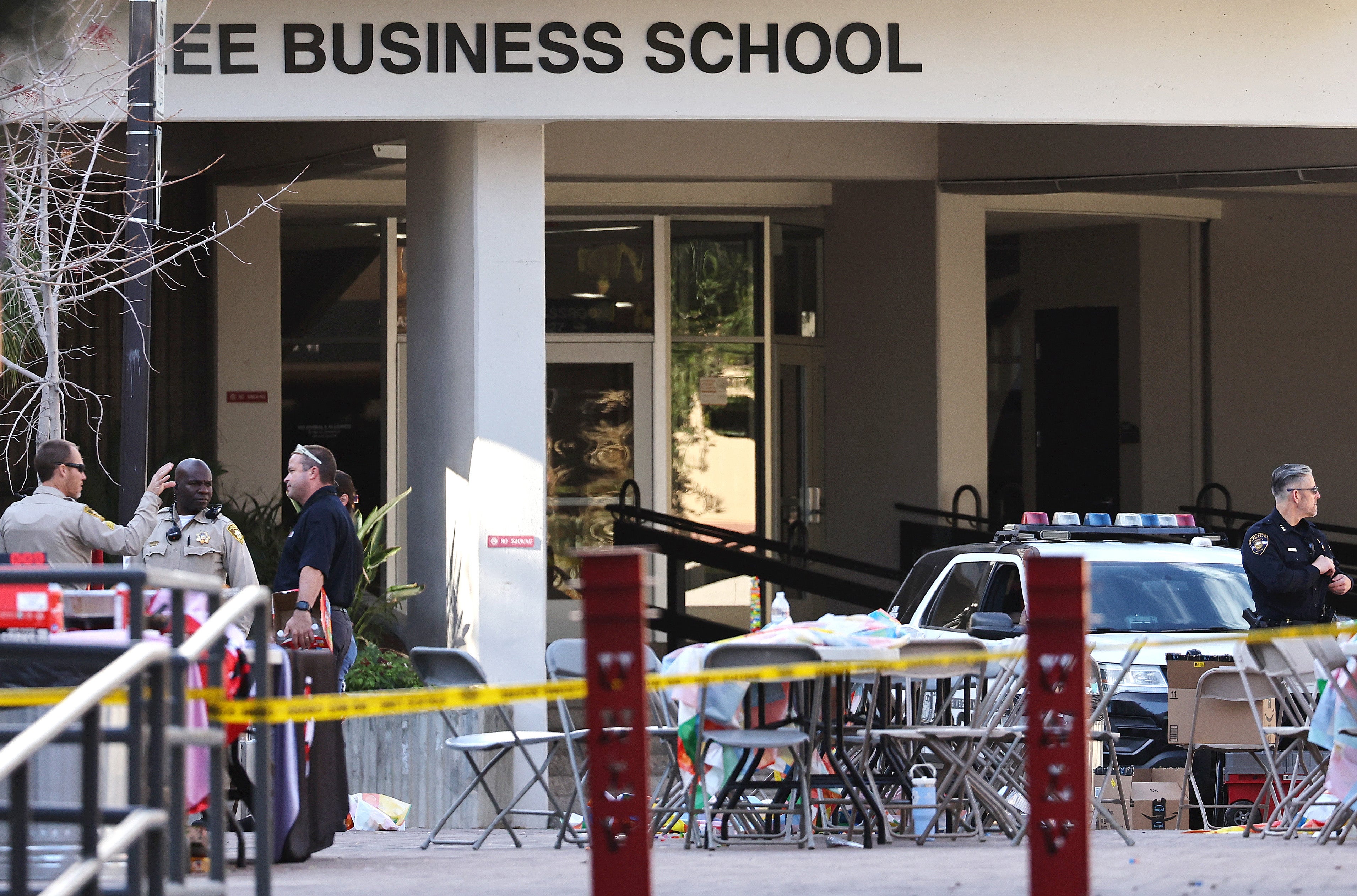 Police officers keep watch near the scene outside Frank and Estella Beam Hall, where the UNLV Lee Business School is located, the morning after a shooting left three dead at the University of Nevada, Las Vegas campus on 7 December 2023 in Las Vegas, Nevada