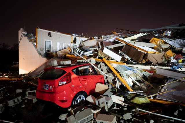 <p>A car is buried under rubble on Main Street after a tornado hit Hendersonville, Tennessee, 9 December2023</p>