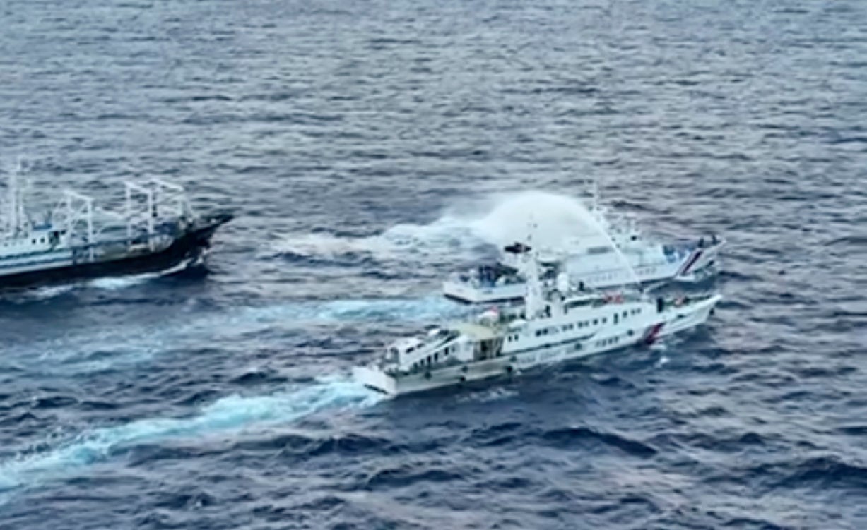 In this image from video handout provided by the Philippine Coast Guard, a Chinese Coast Guard ship, bottom, uses water cannon Philippine coast guard patrol ship, BRP Cabra, center, as it approaches Second Thomas Shoal, locally known as Ayungin Shoal, in the disputed South China Sea on Sunday 10 December 2023