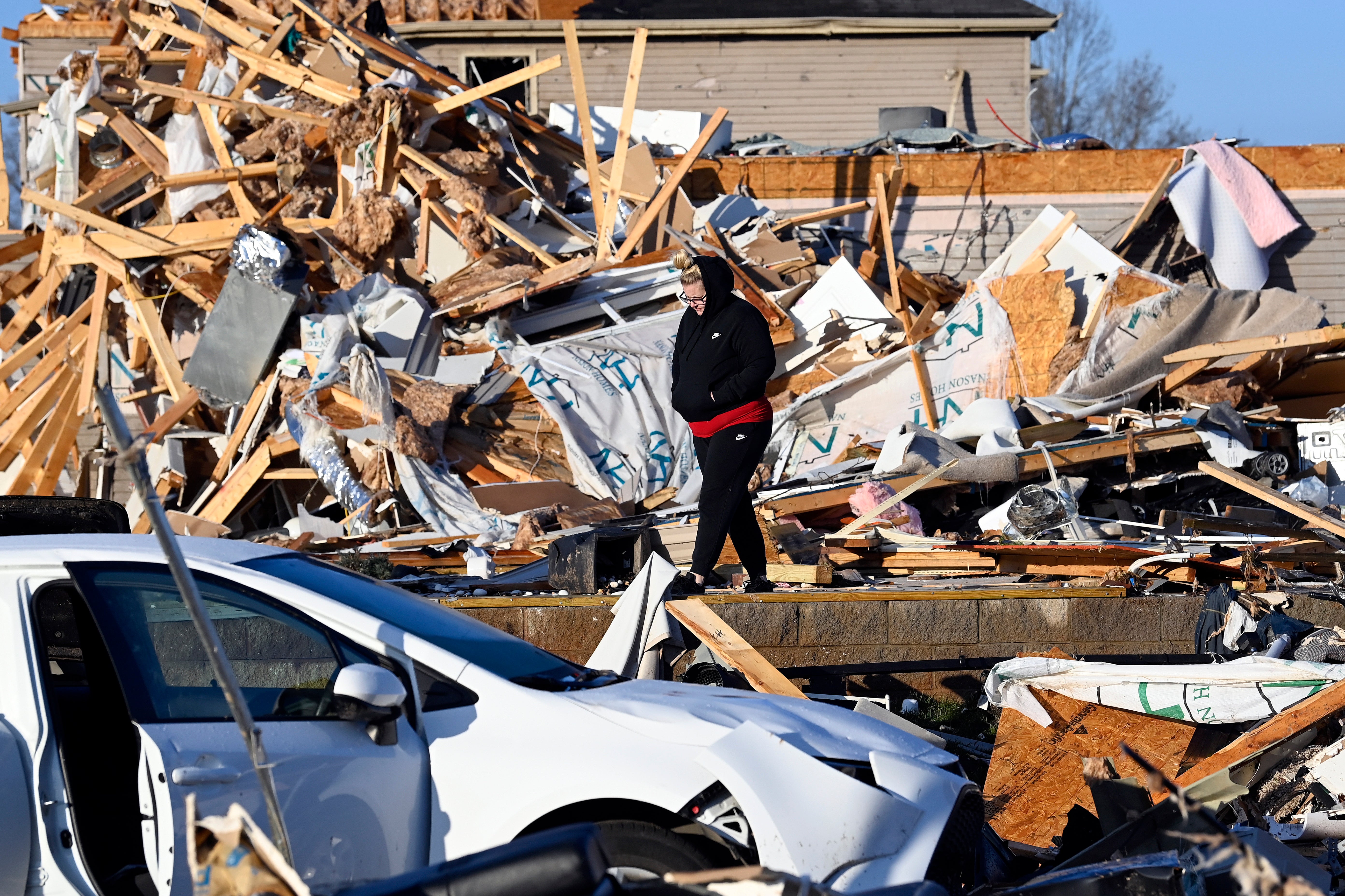 A resident examines the debris from a friend’s destroyed house in Clarksville, Tennessee
