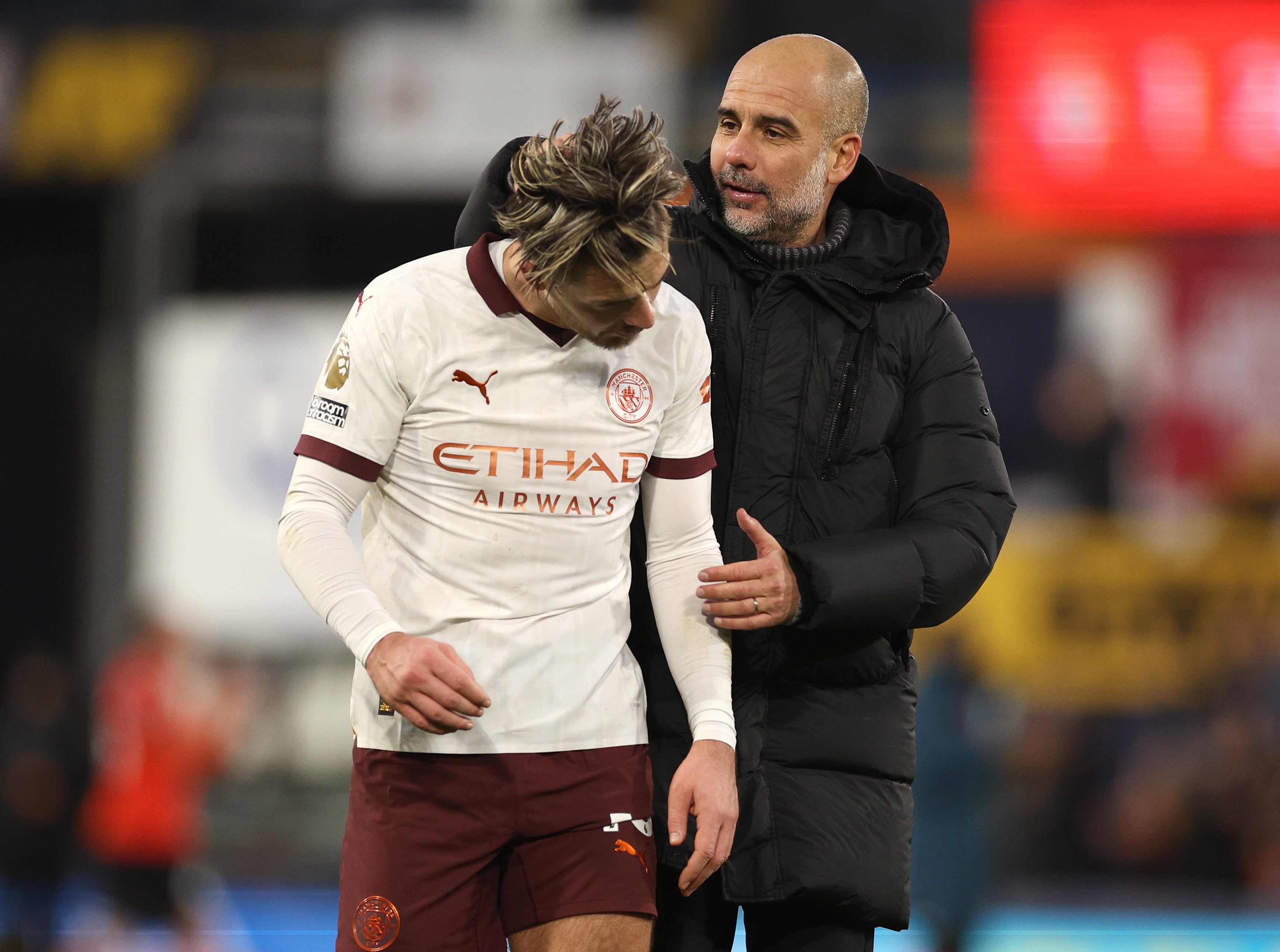 Jack Grealish and Pep Guardiola celebrate an important win for Man City