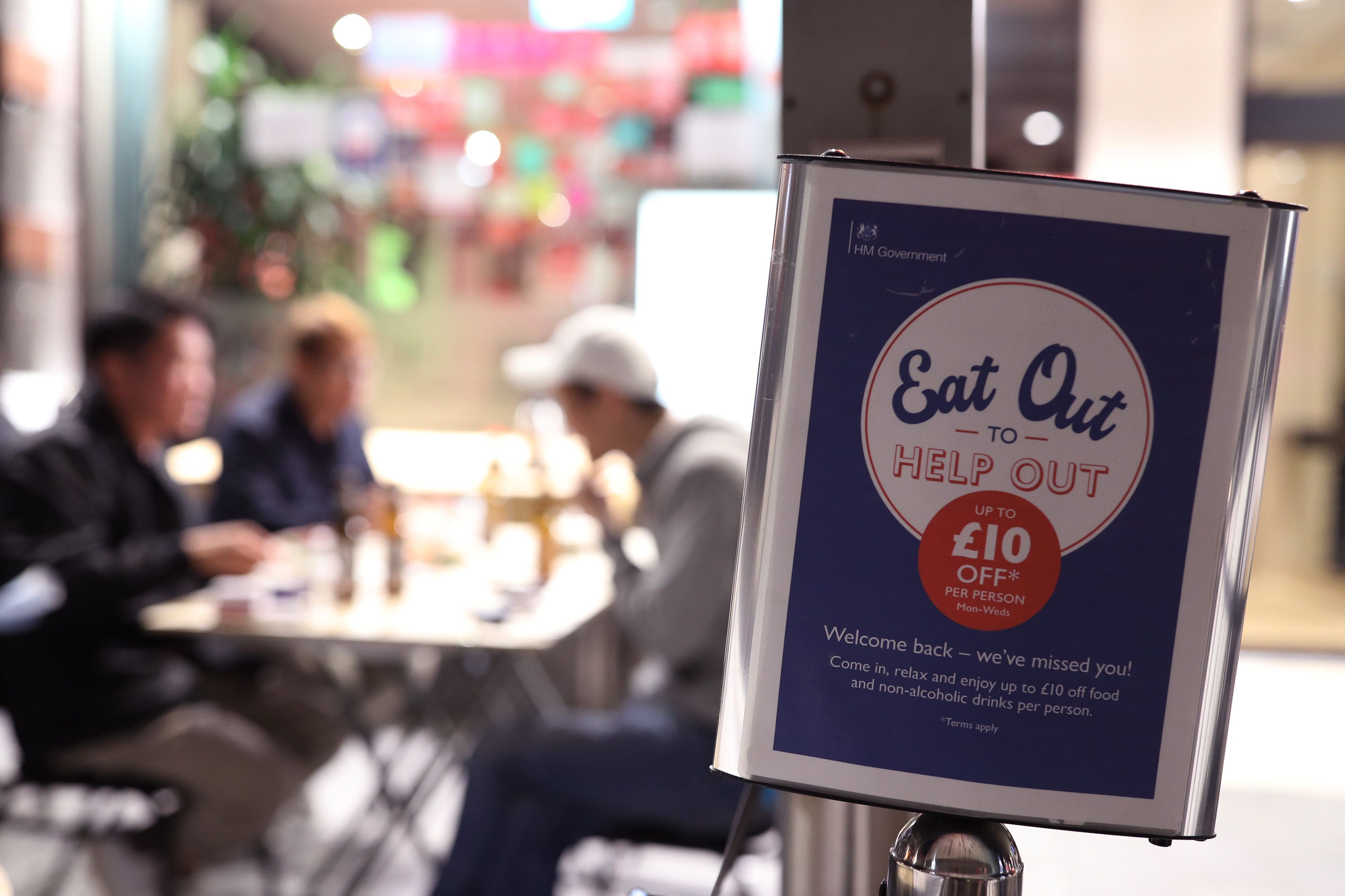 People eating outside a restaurant in Chinatown in Soho during the Eat Out to Help Out scheme (Yui Mok/PA)