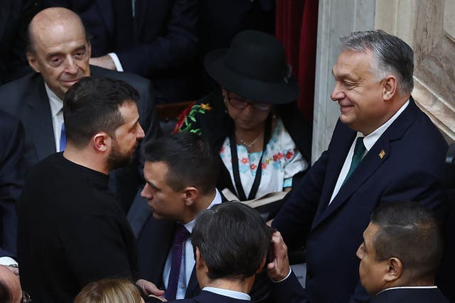 <p>Volodymyr Zelensky (L) chats with Hungary’s prime minister Viktor Orban (R) during the inauguration of Argentina’s new president Javier Milei at the Congress in Buenos Aires</p>