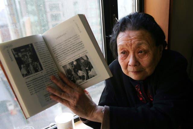 <p>Gao Yaojie in 2007, with her book ‘Prevention of Aids and Sexually Transmitted Diseases’</p>