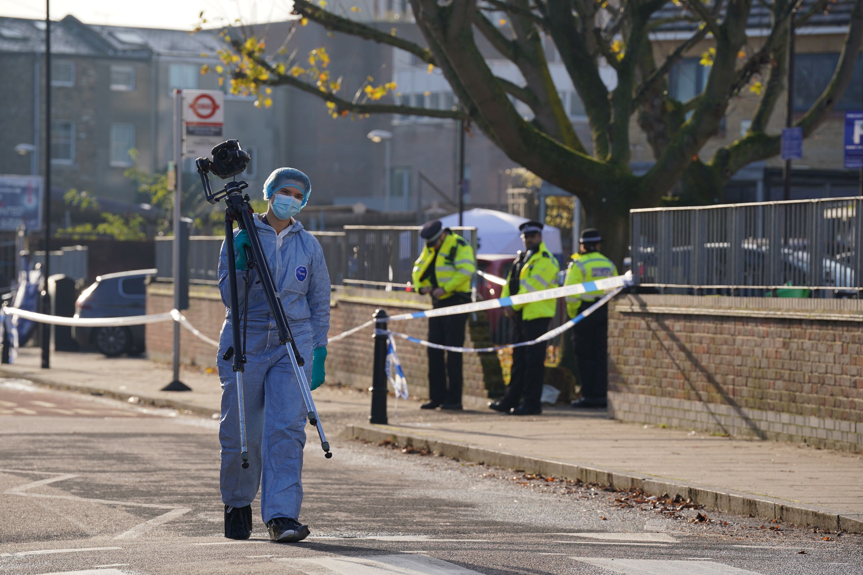 Police officers at the scene of the shooting near Vine Close, Hackney (Lucy North/PA)