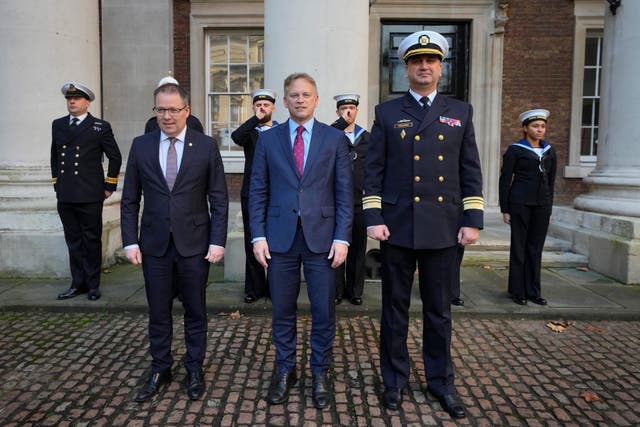 <p>British Defense Secretary Grant Shapps, center, poses with Ukrainian Vice Admiral Oleksii Neizhpapa, right, and Norwegian Defense Minister Bjorn Arild Gram in London in December </p>