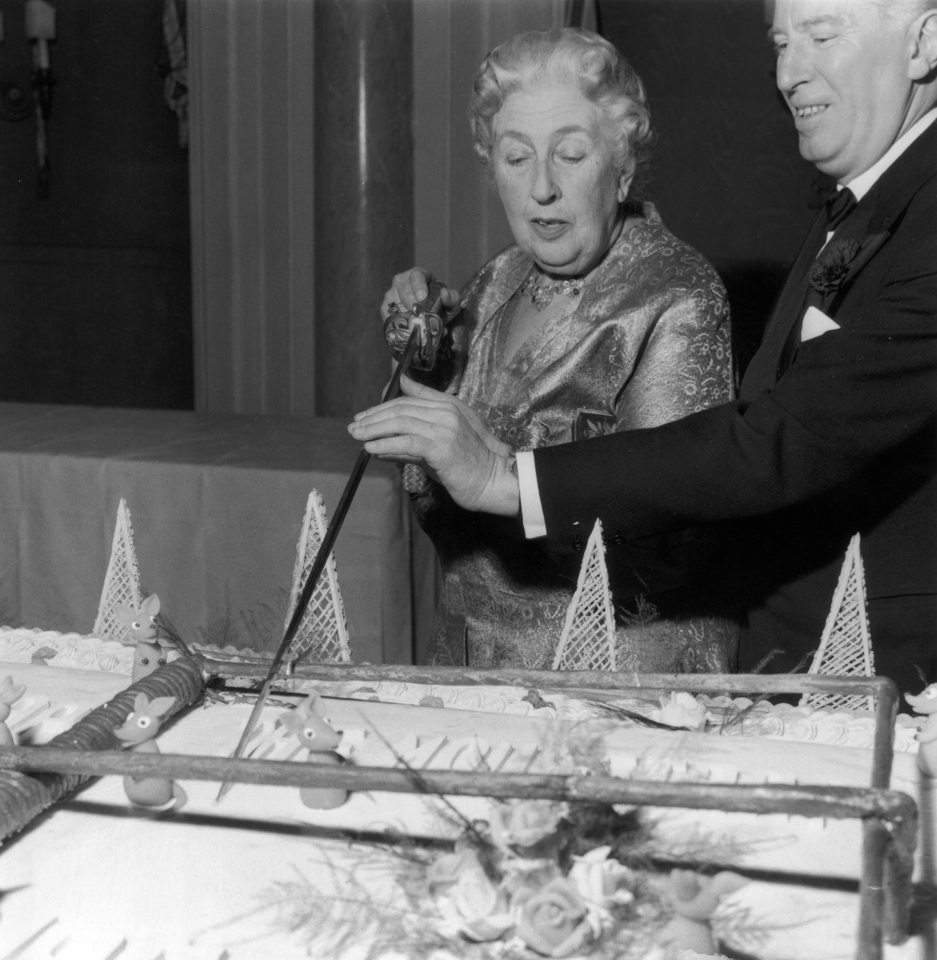 Christie cuts an enormous cake at a party on 26 November 1962 to celebrate the 10th anniversary of her play ‘The Mousetrap’